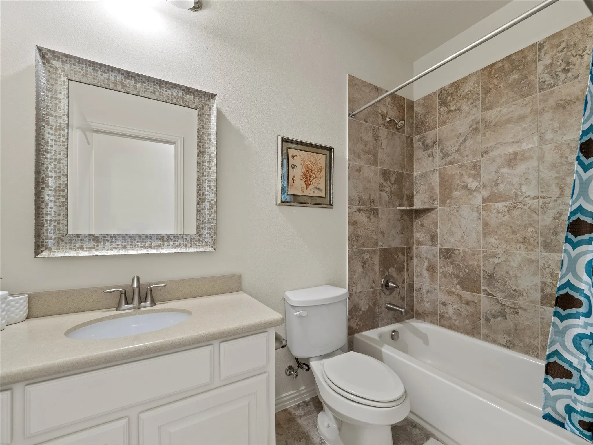 Bathroom featuring vanity and shower / tub combo with curtain