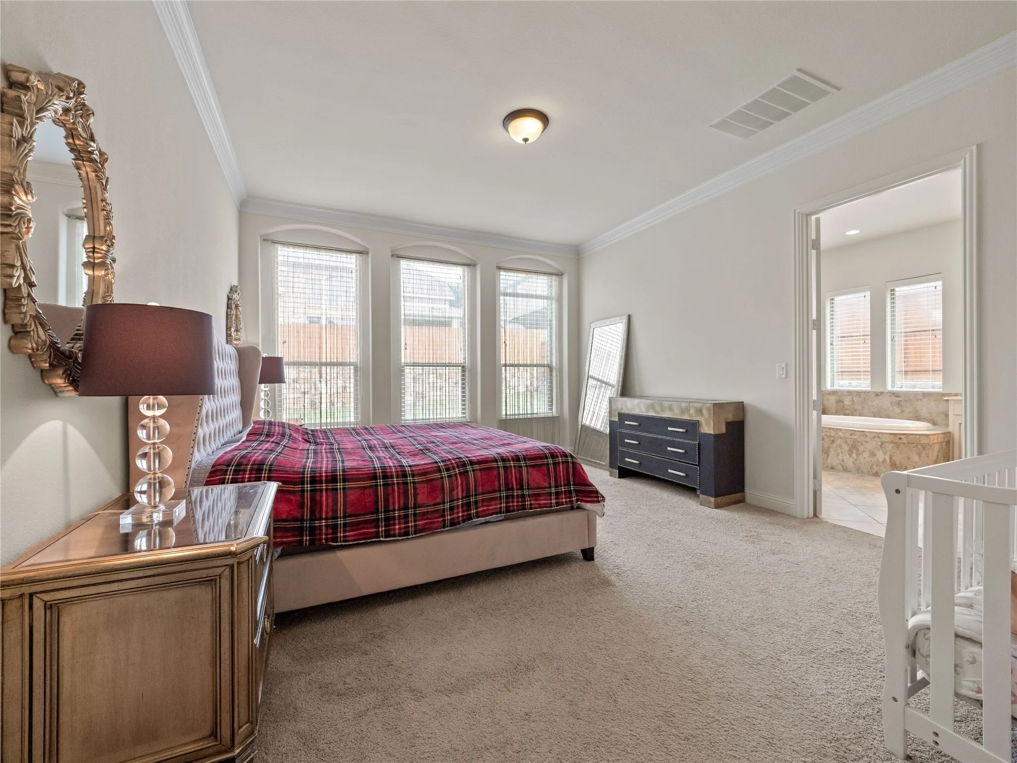 Bedroom with light carpet and crown molding