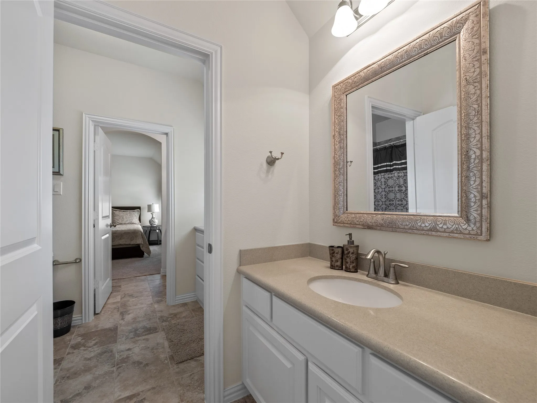 Bathroom with vanity, a shower with curtain, and ensuite bath