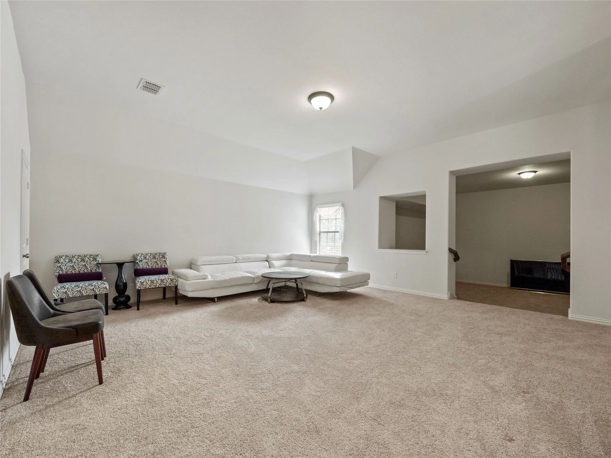 Living room featuring light carpet and lofted ceiling