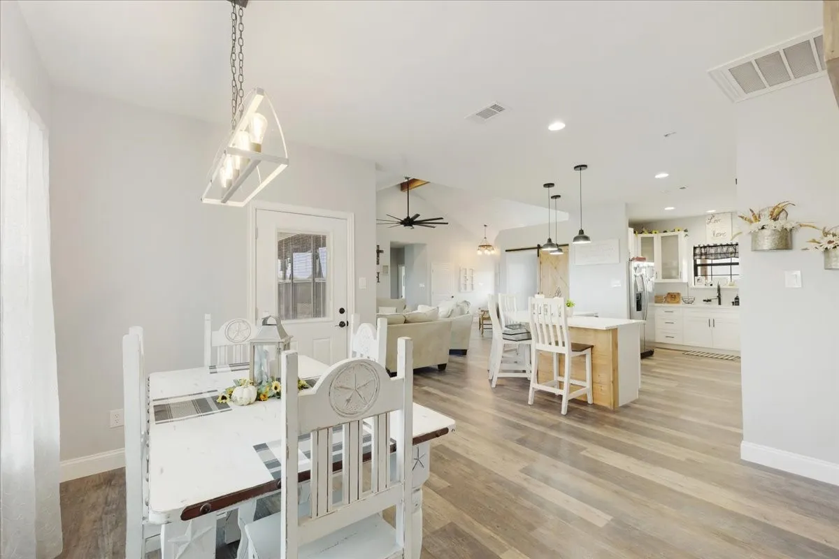 View from breakfast nook looking towards kitchen, living are and office entry; Main home