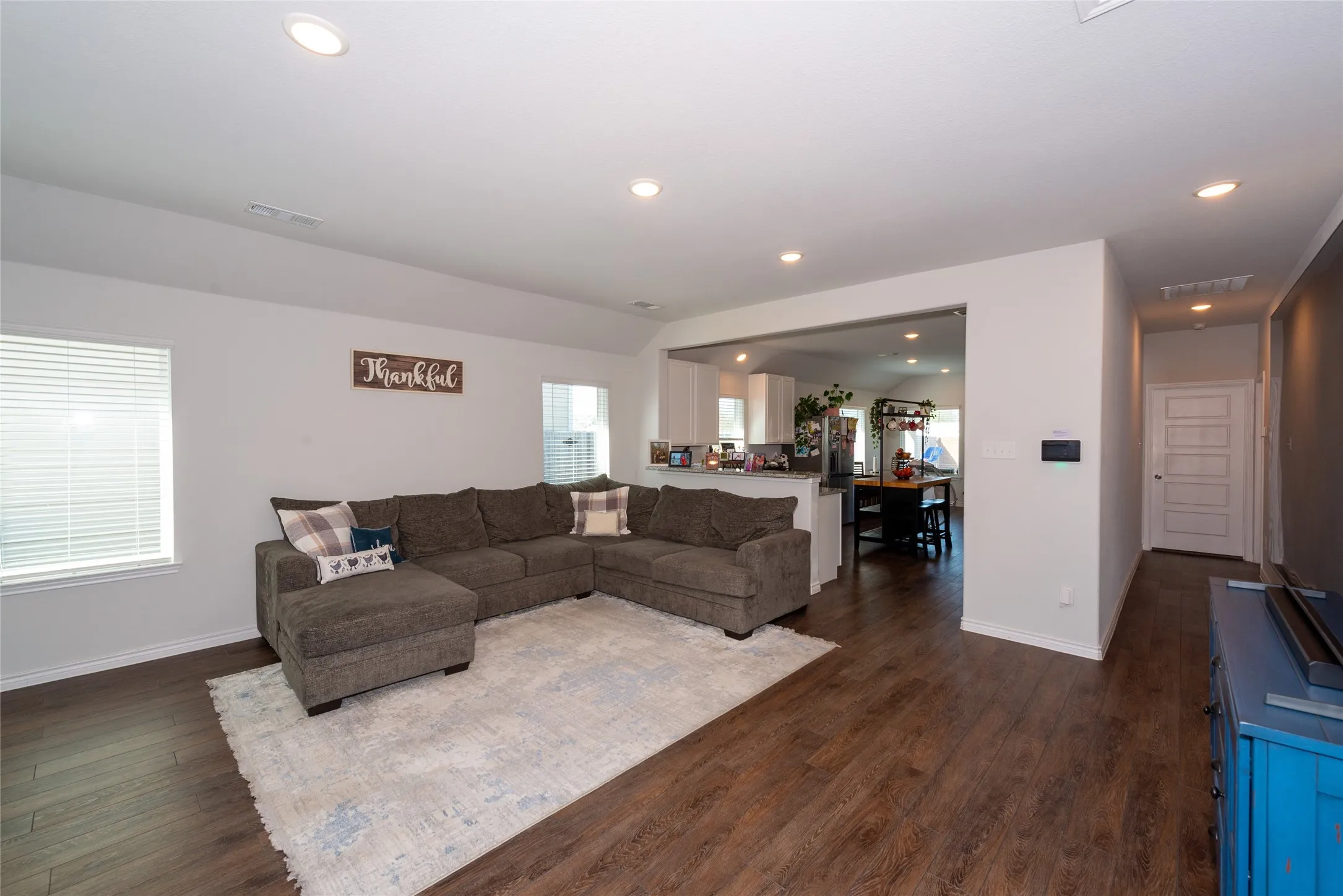 Living room featuring dark wood finished floors and recessed lighting