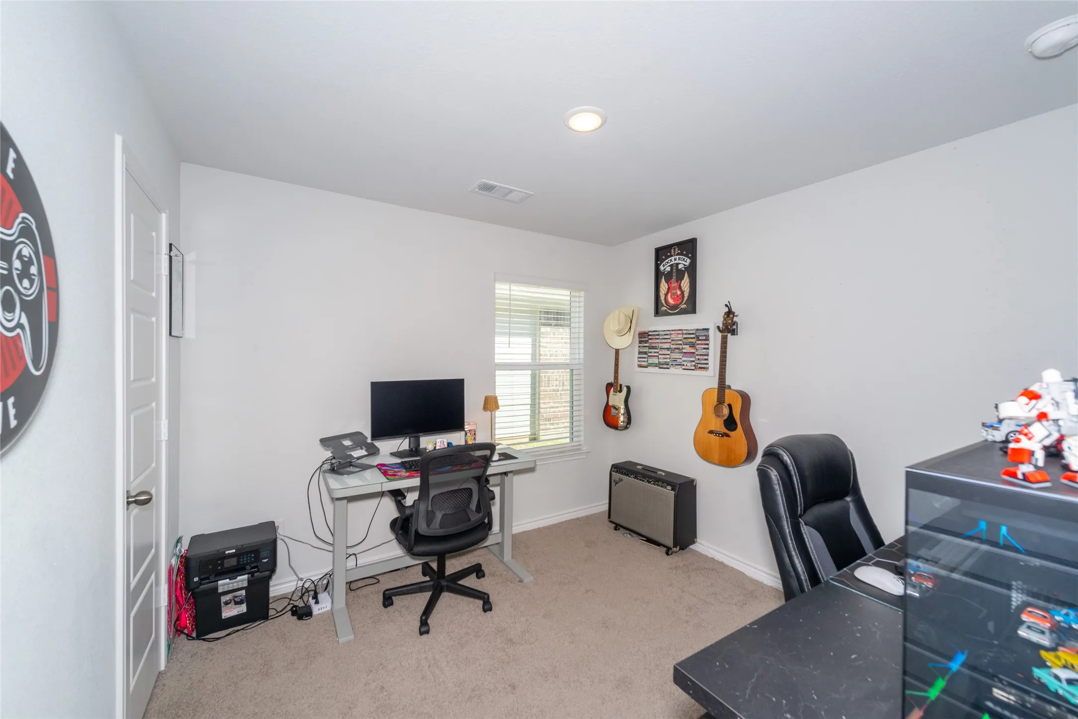 Office featuring light colored carpet and baseboards