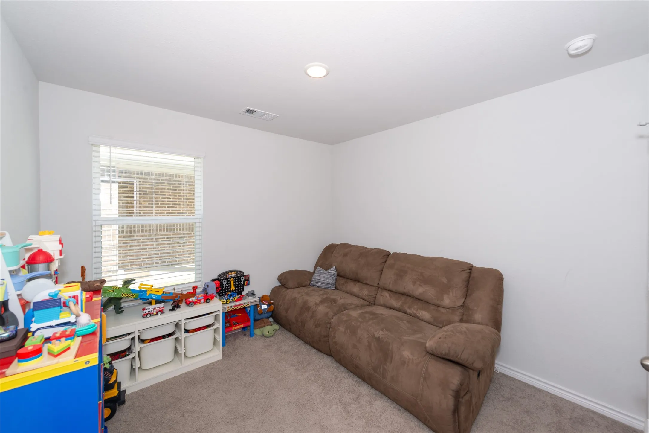 Game room featuring light carpet