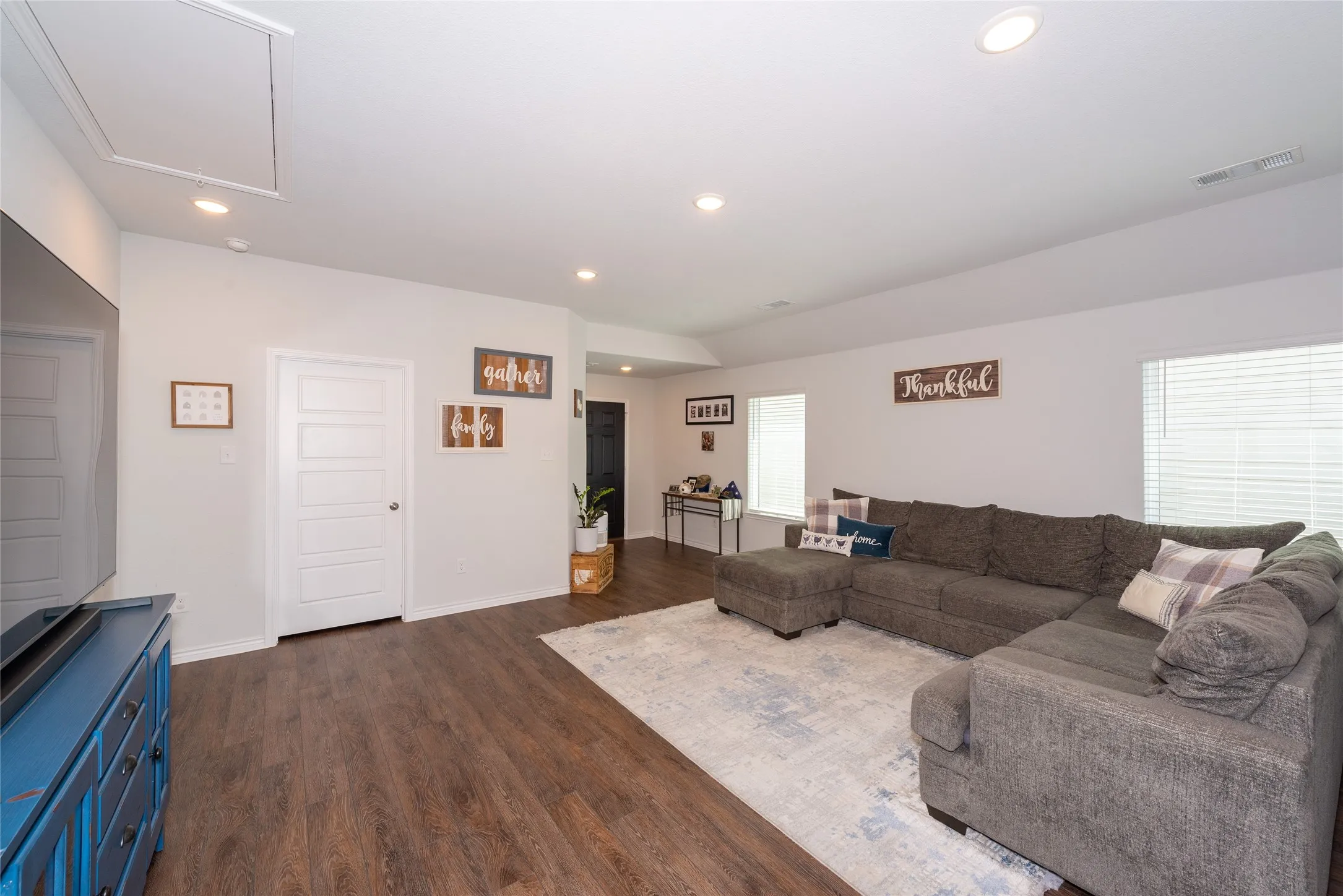 Living room featuring dark wood-style floors and recessed lighting