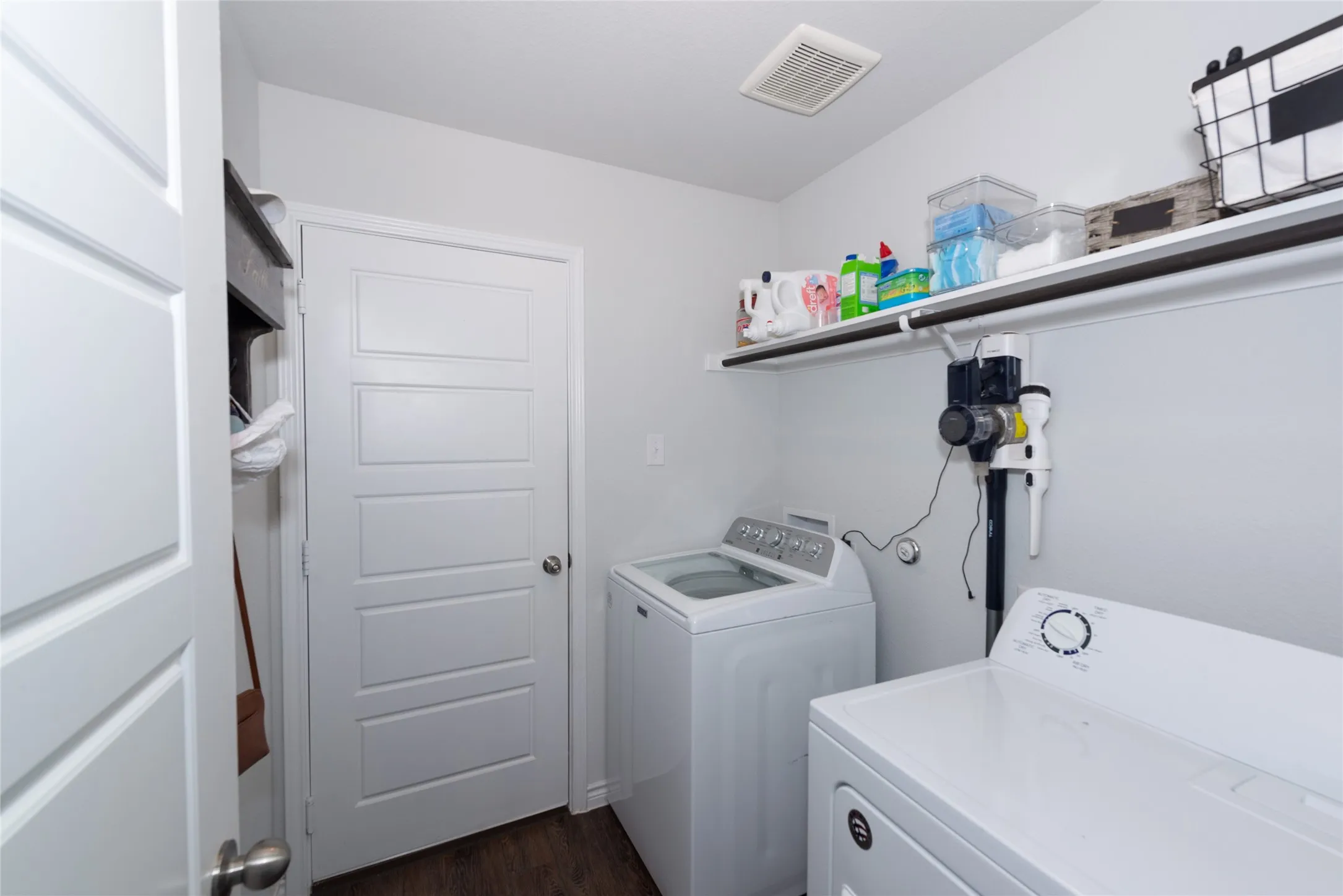 Laundry area featuring washing machine and dryer and dark wood-style floors