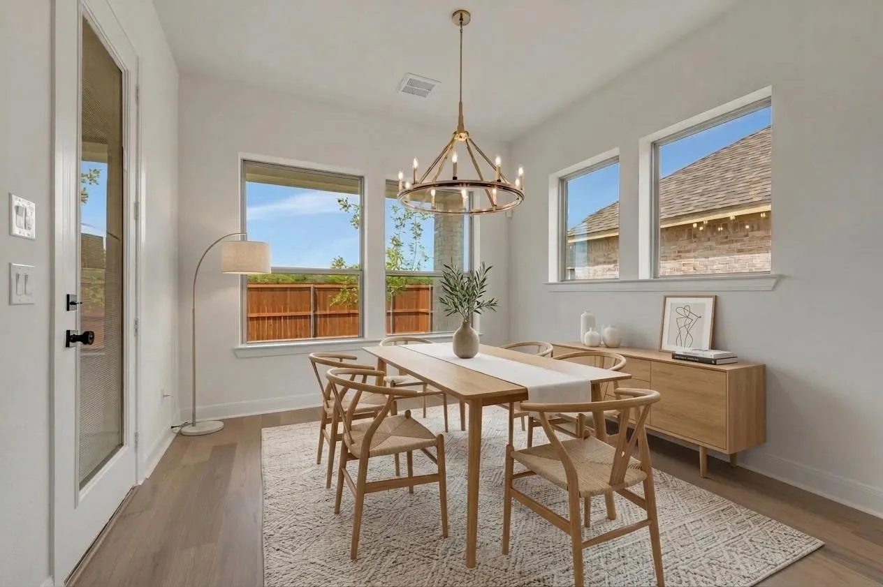 Wood-finish flooring, multiple windows, a chandelier-style light fixture, and a built-in buffet cabinet