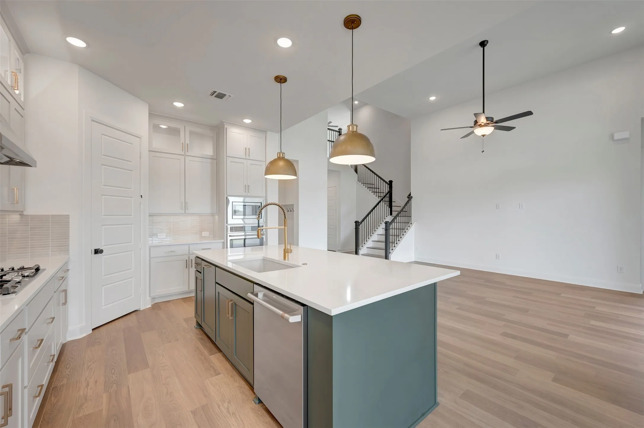 Kitchen island featuring a single-basin sink and stainless steel appliances