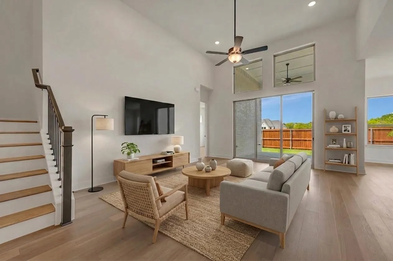 High ceilings with recessed lighting, wood-finish flooring, staircase with wood newel post and balusters, sliding glass door, and backyard patio