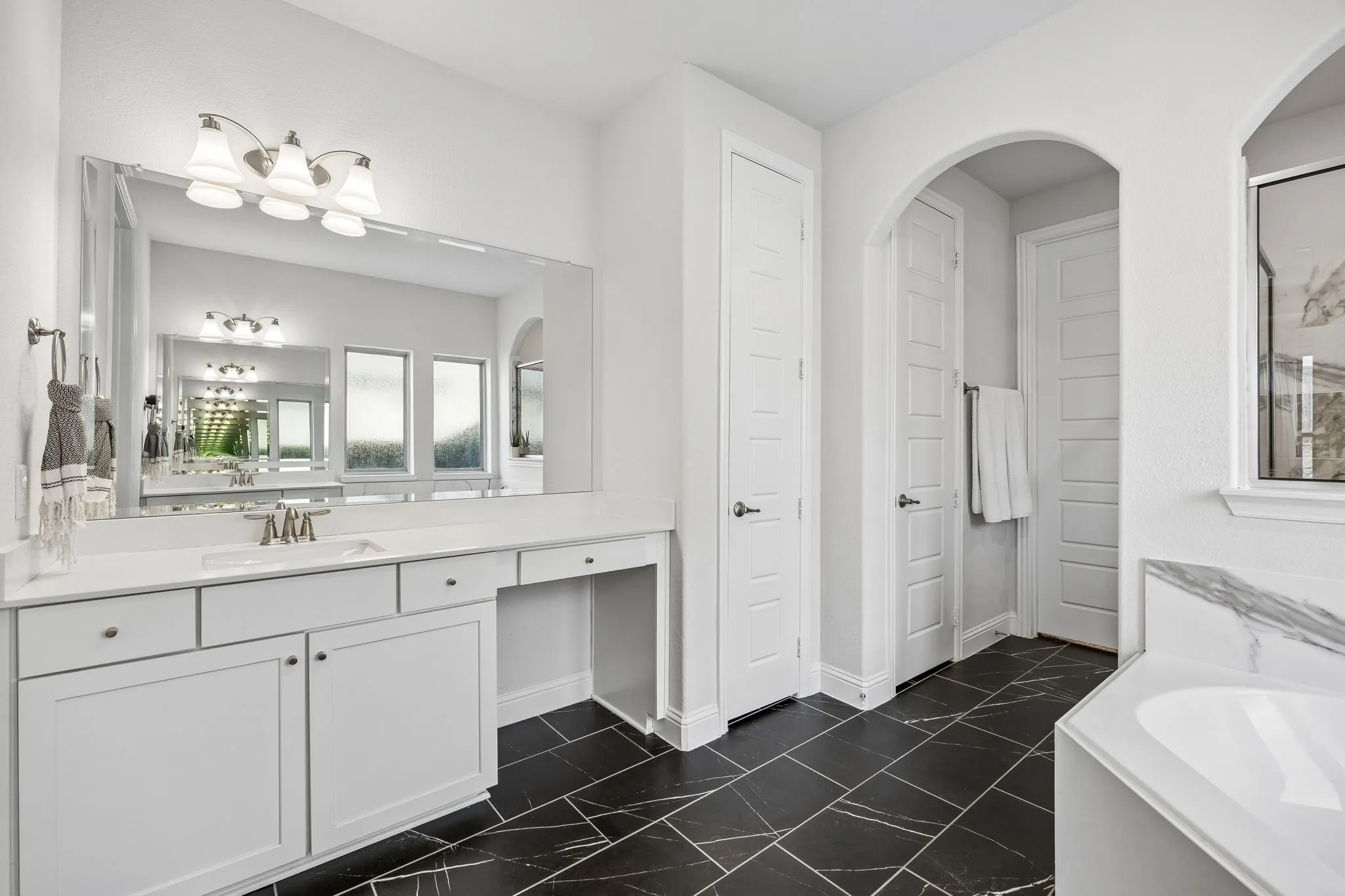 Bathroom with vanity and a bath