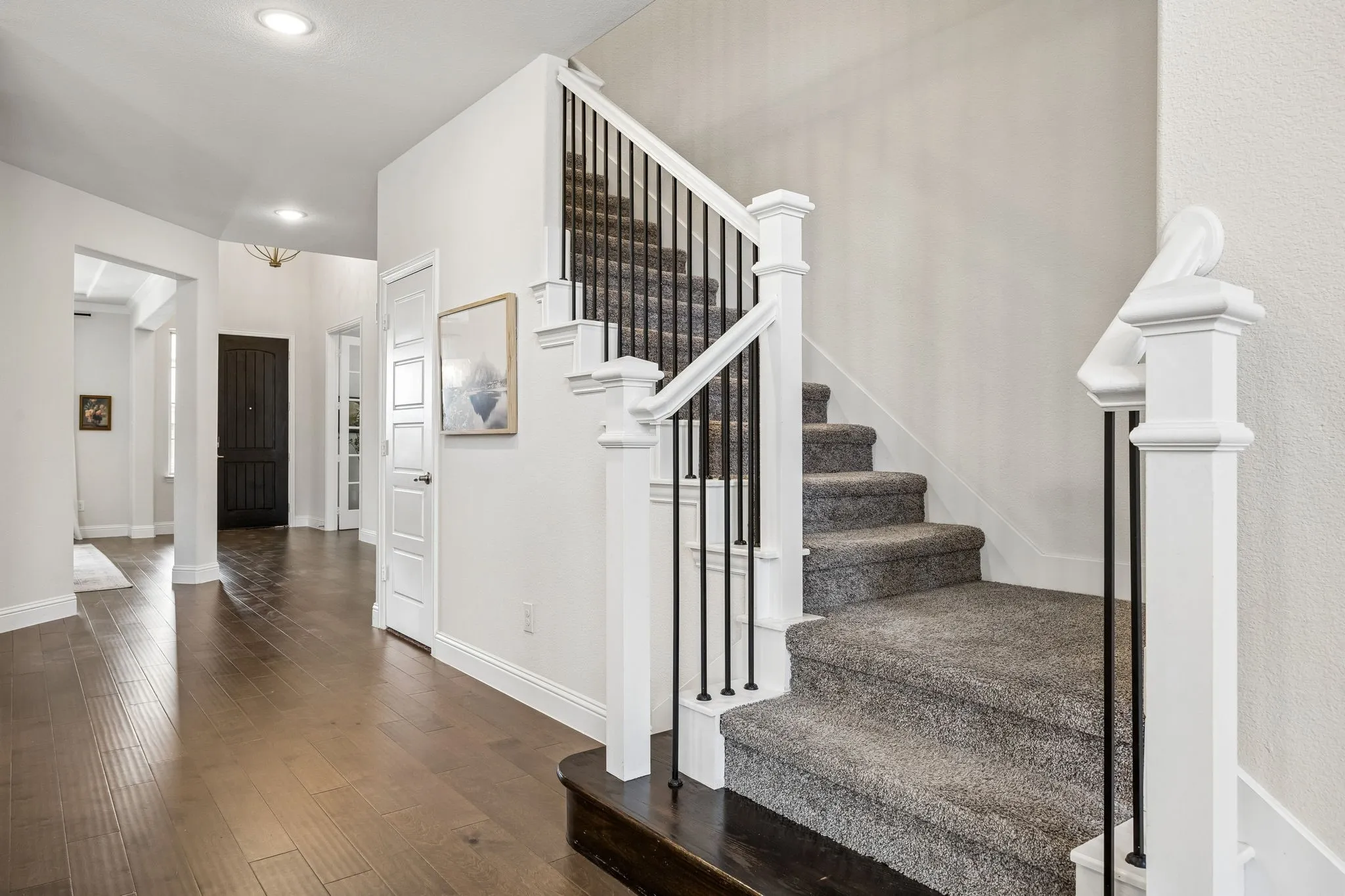 Stairway with hardwood / wood-style flooring and recessed lighting
