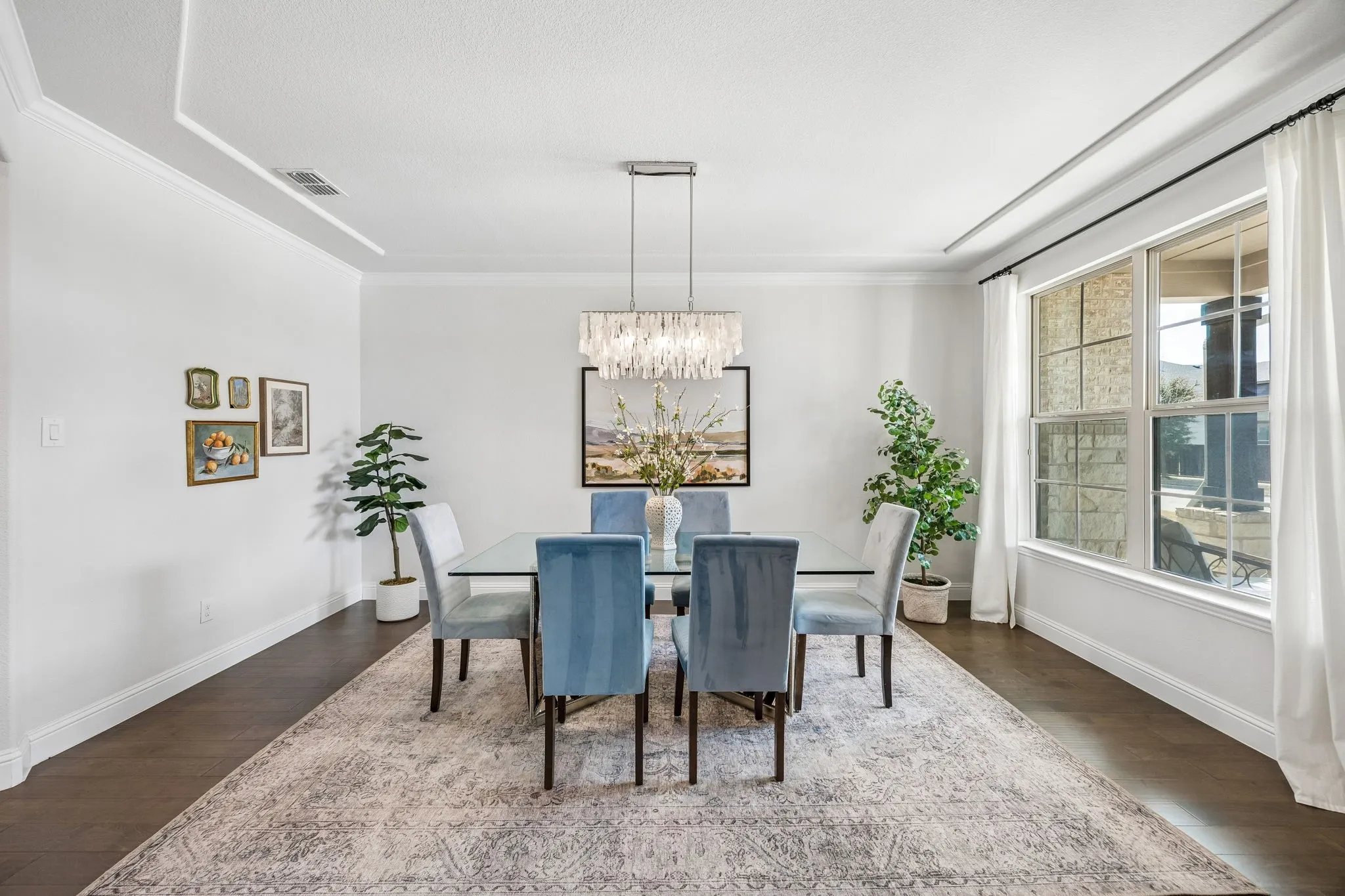 Dining space featuring dark wood finished floors, a chandelier, and ornamental molding