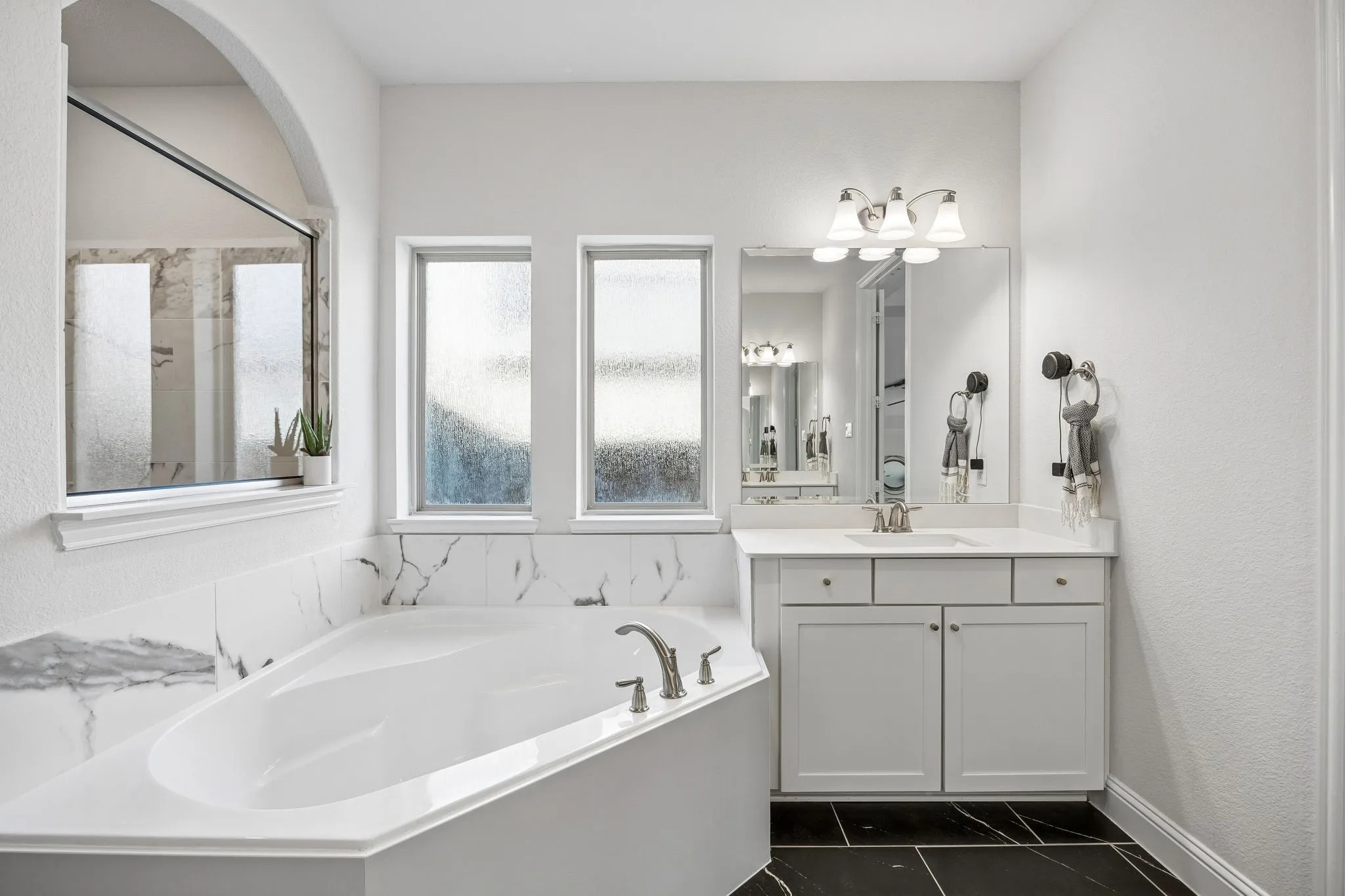 Bathroom with a bath and vanity