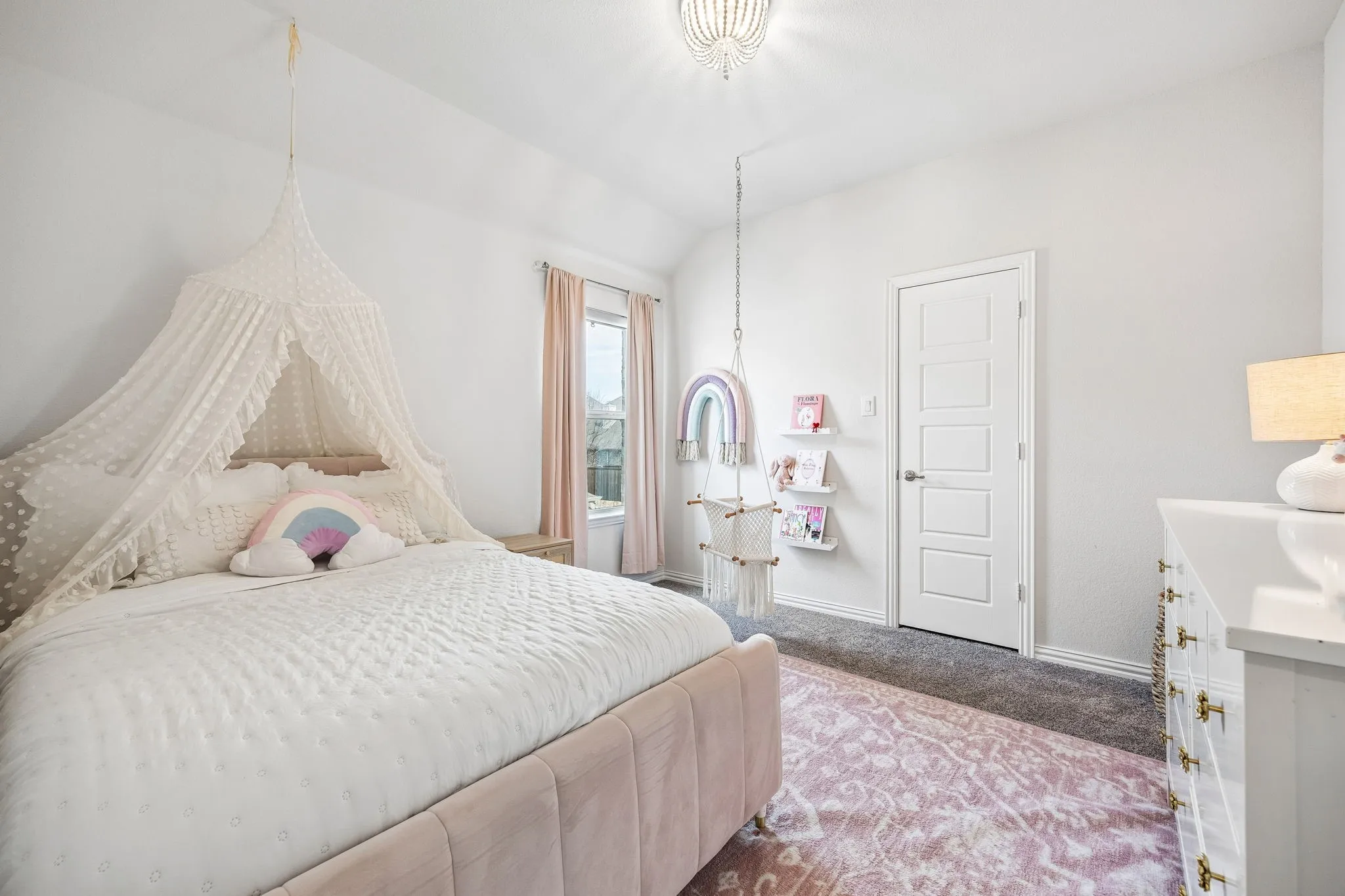 Carpeted bedroom featuring baseboards and lofted ceiling