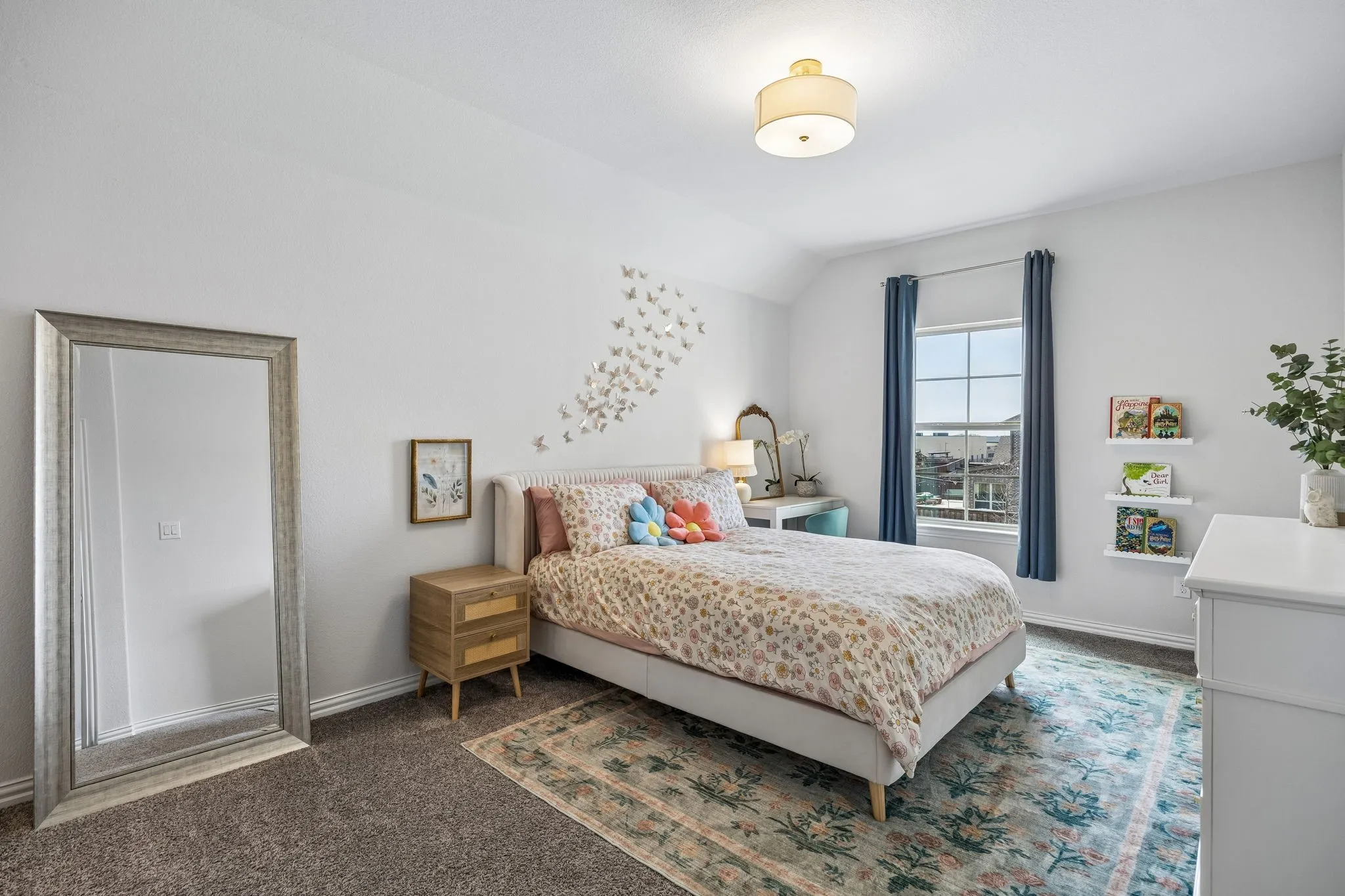 Bedroom with dark carpet and vaulted ceiling