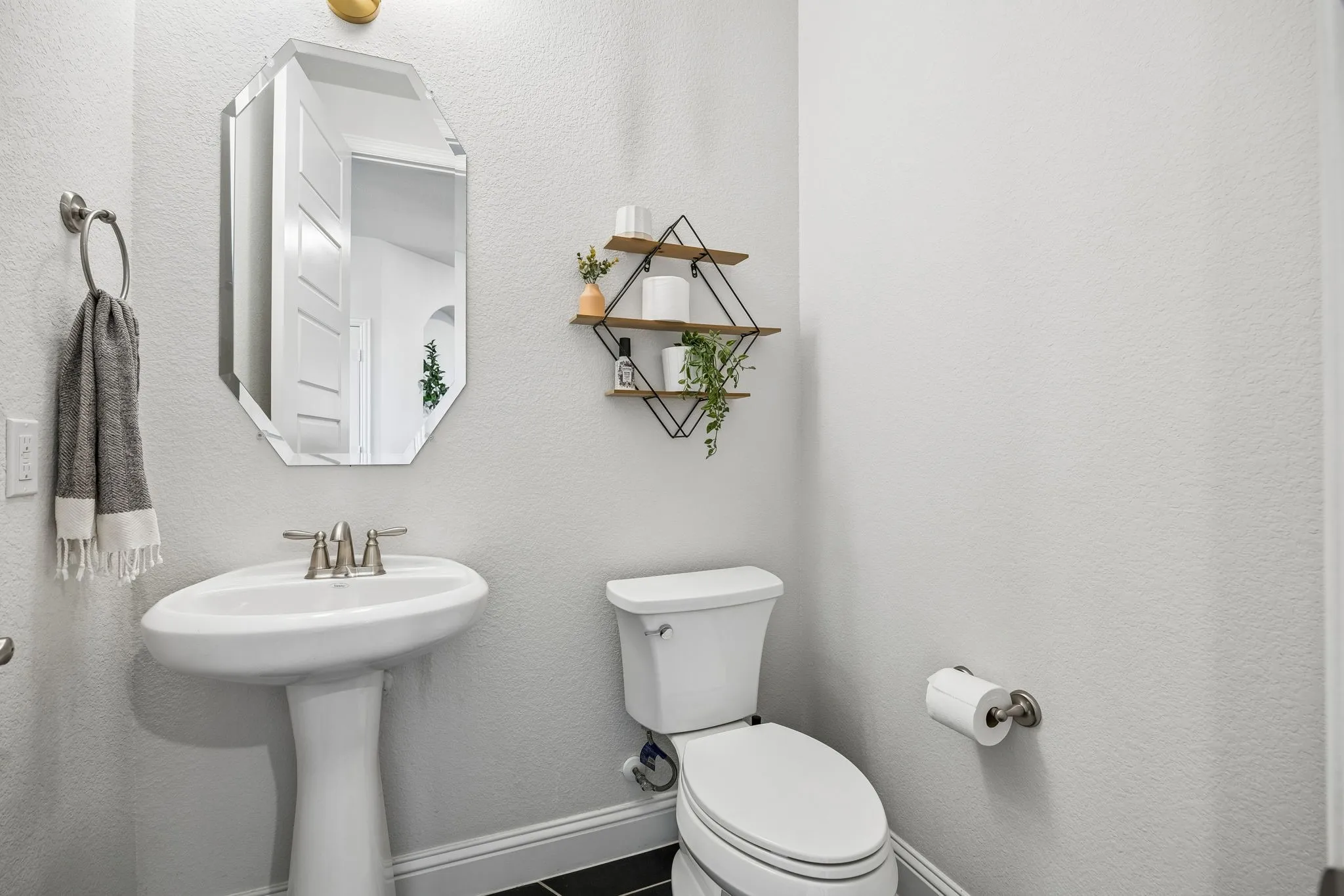 Bathroom featuring toilet and a textured wall
