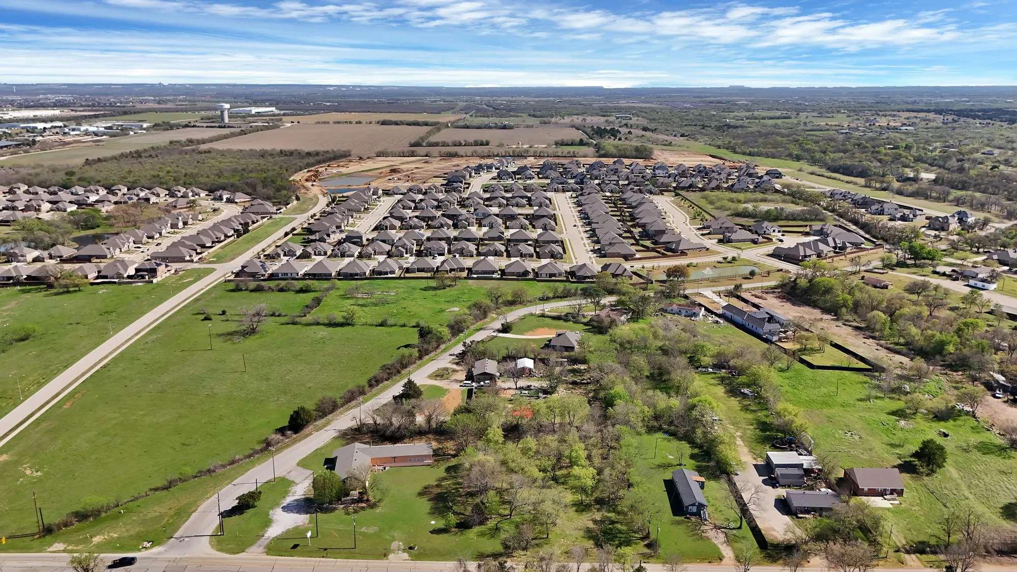 Aerial overview of property's location with nearby suburban area