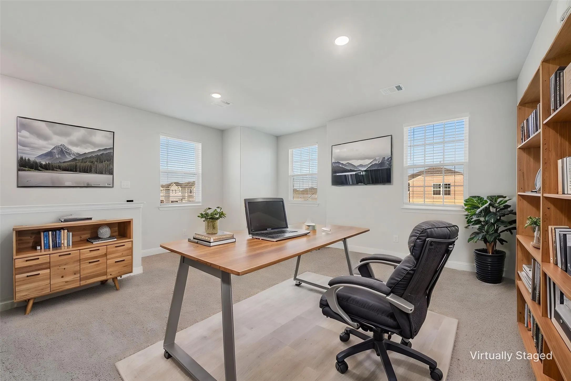 Recessed lighting, light gray wall paint, multiple windows, built-in shelving, and carpeting
