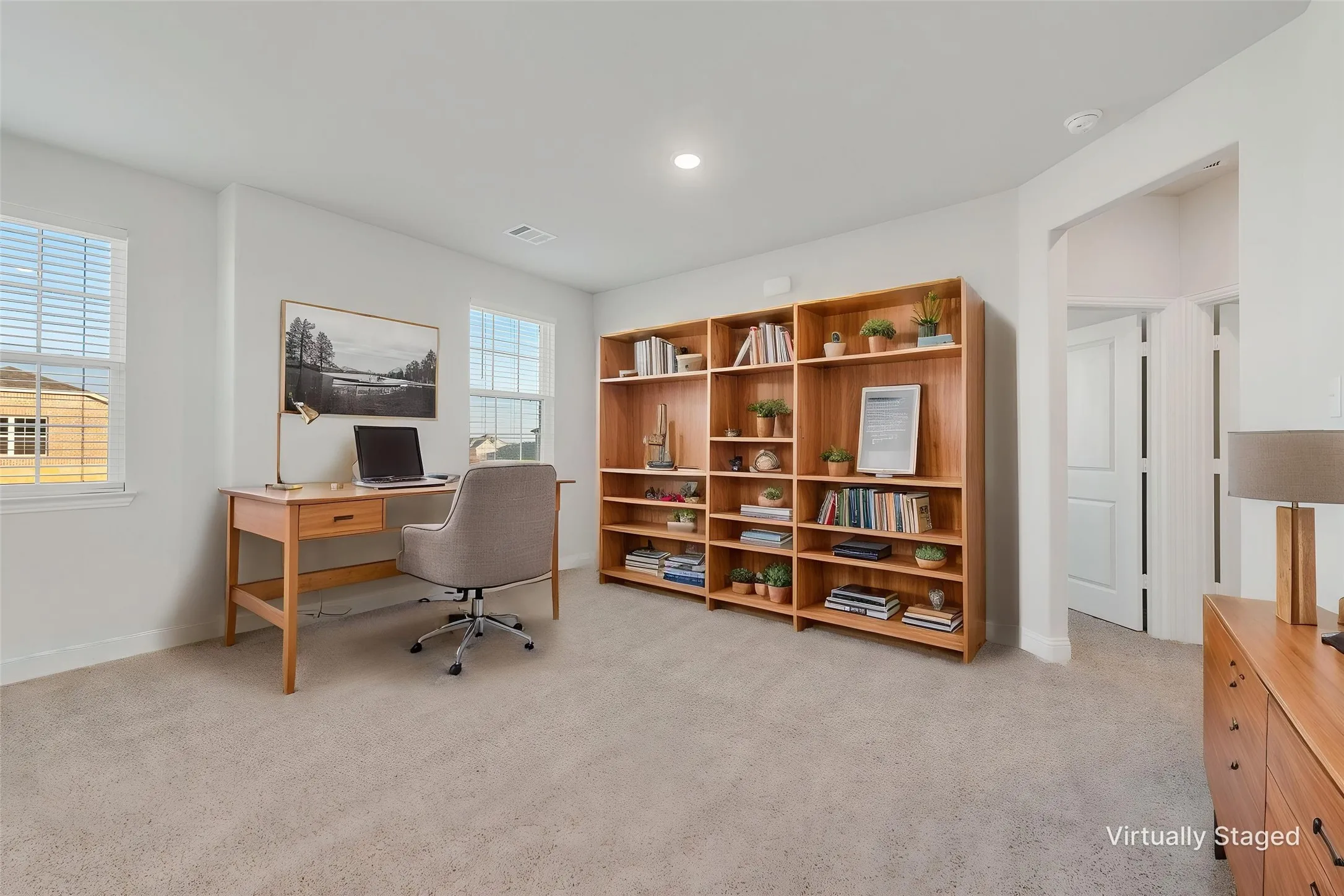 Built-in wood shelving, arched doorway, recessed lighting, and dual windows with blinds