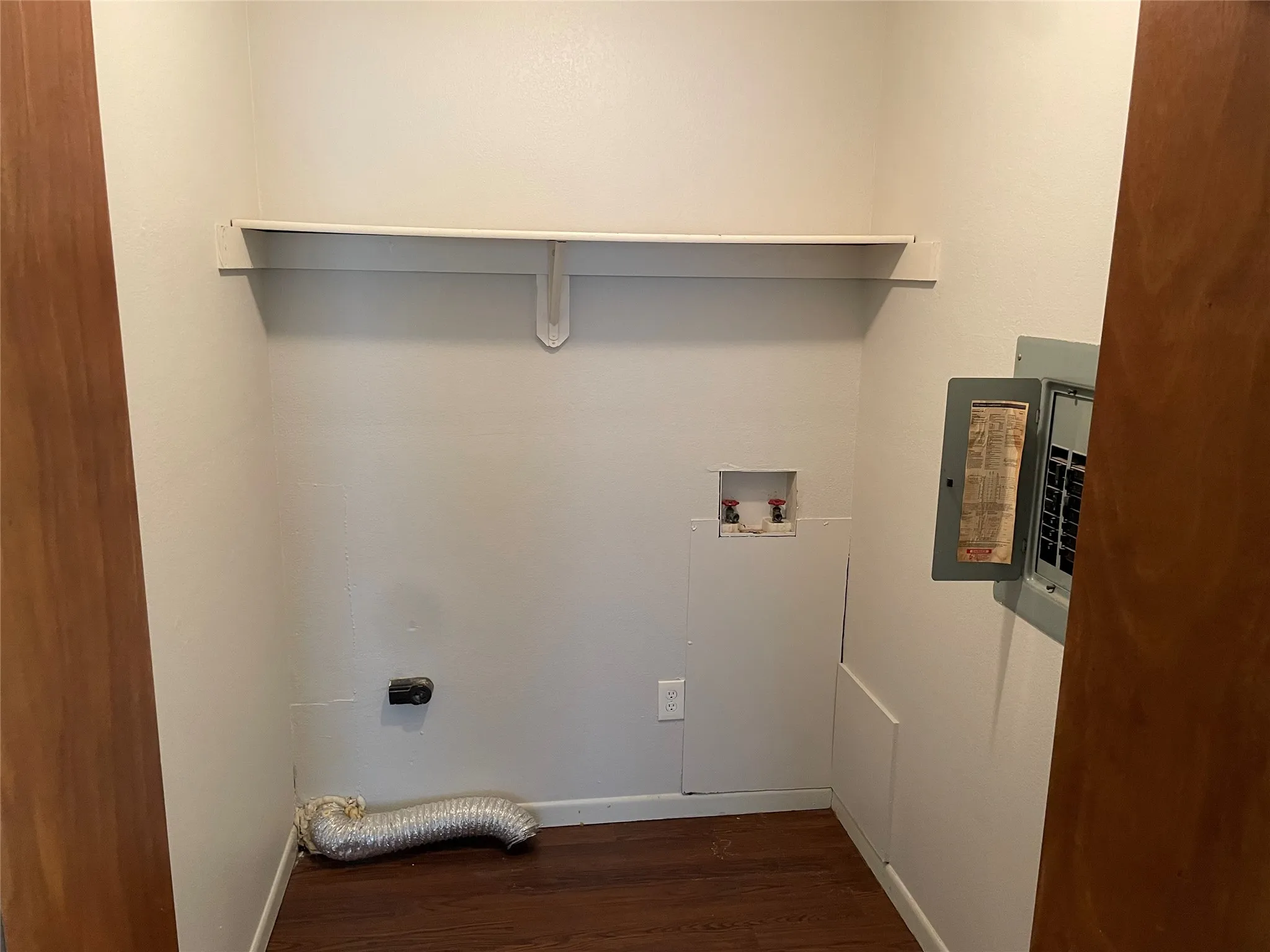 Laundry room featuring electric panel, dark wood-type flooring, hookup for an electric dryer, and washer hookup
