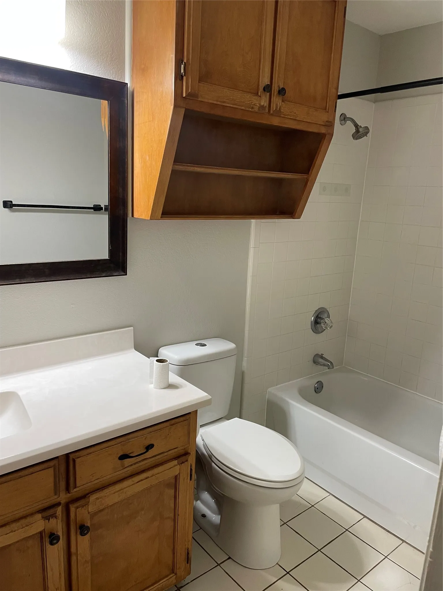 Bathroom featuring vanity, bathing tub / shower combination, and light tile patterned floors
