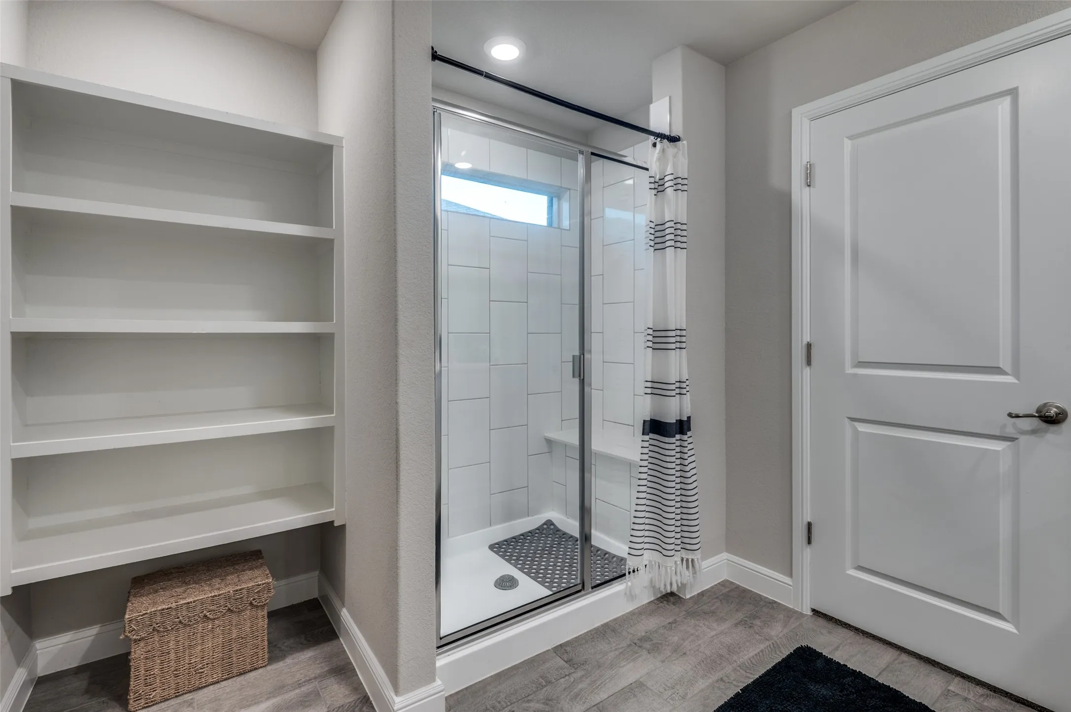 Full bathroom with a stall shower and light wood-type flooring