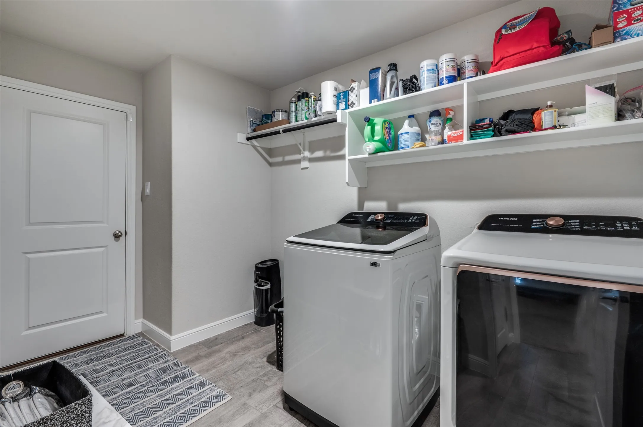 Laundry area featuring washer and clothes dryer and light wood finished floors