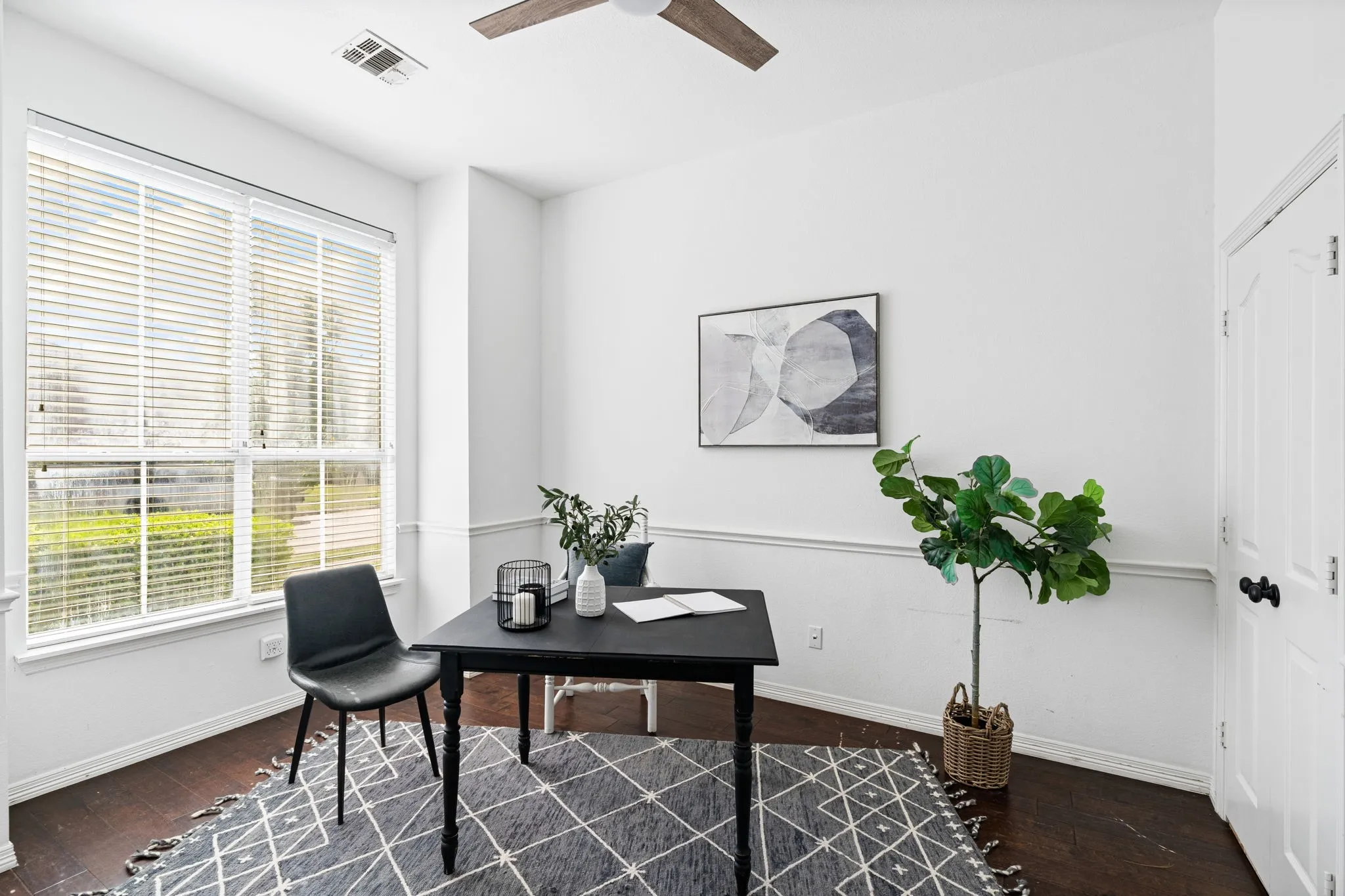 Office area featuring dark wood-type flooring and a ceiling fan
