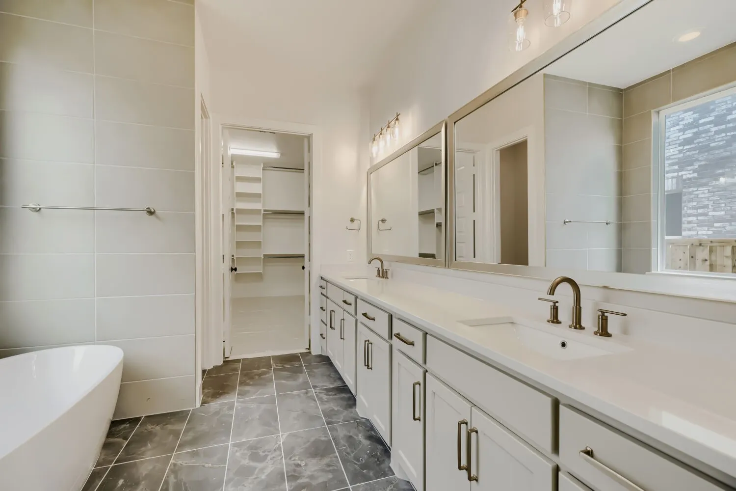 Dual vanity with undermount sinks and bronze-finish fixtures