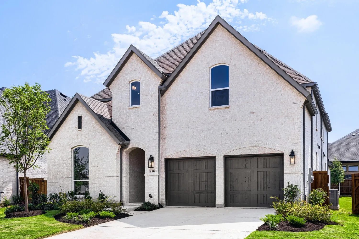 White brick exterior featuring a dark asphalt shingle roof