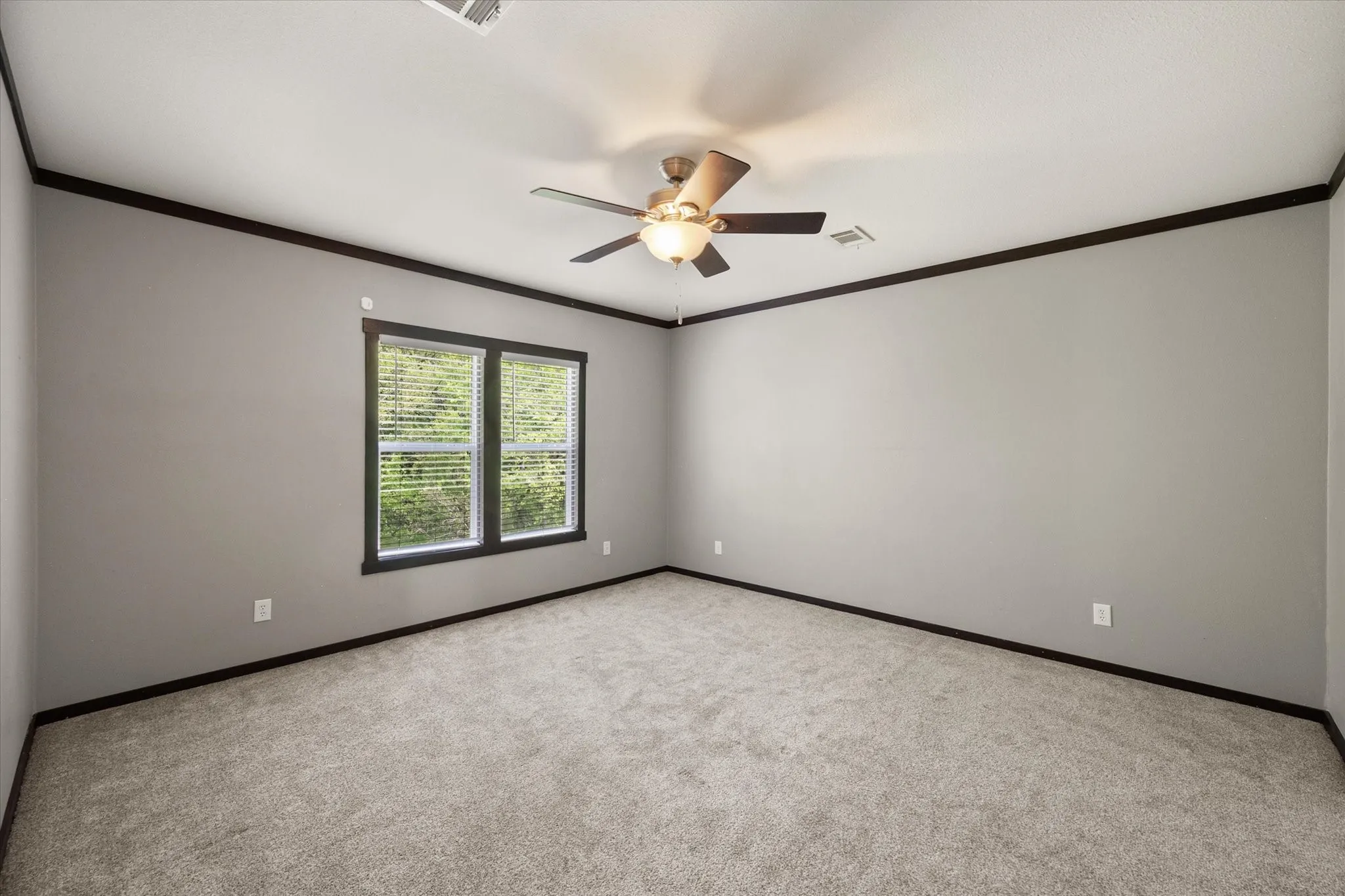 Large primary suite with soft natural light and neutral finishes creates a relaxing private retreat.