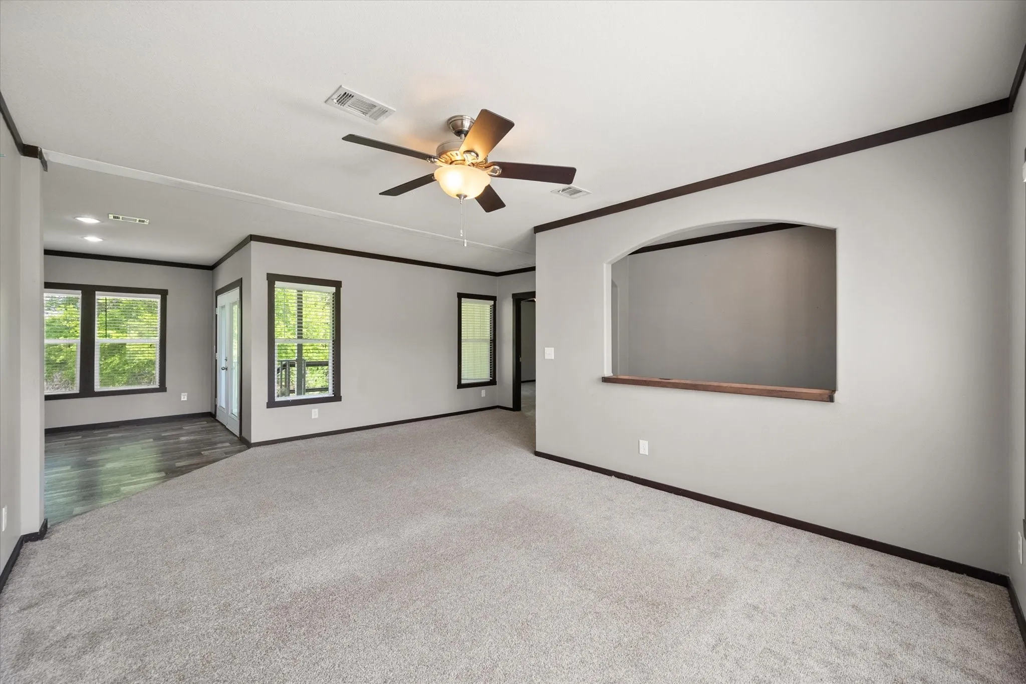 Generous family room with neutral finishes and flexible layout ideal for full-time living or weekend lake escapes.
