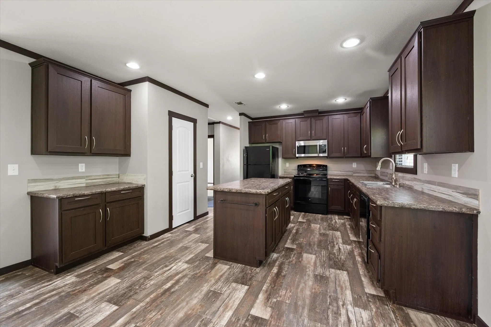 Well-designed kitchen featuring abundant cabinetry, recessed lighting, and generous prep space for everyday living.