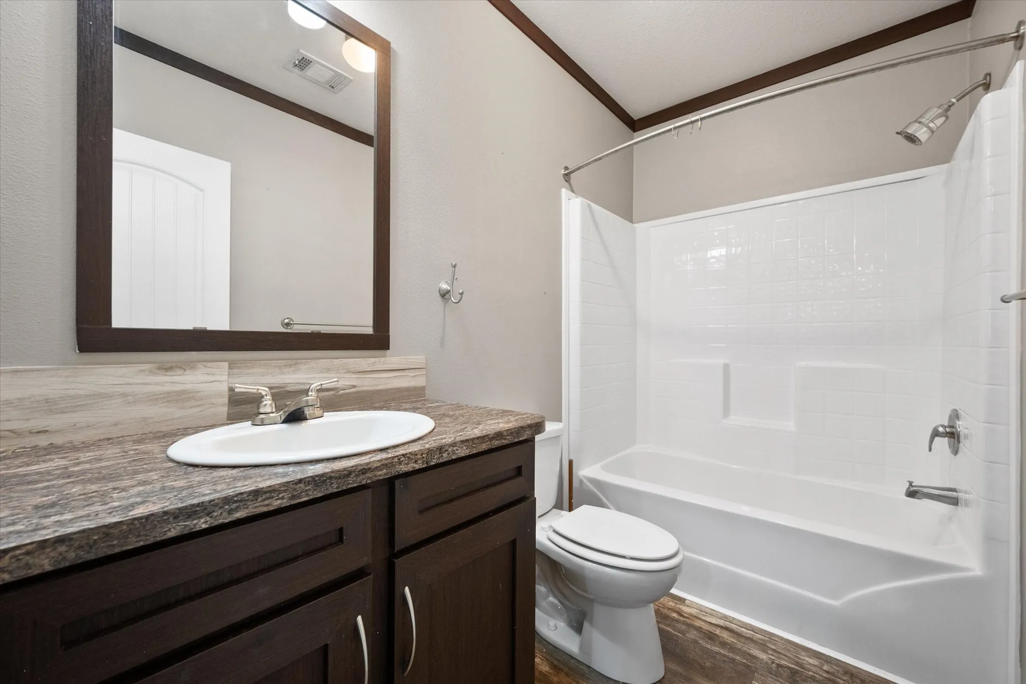 Well-maintained guest bathroom with tub-shower combination and stylish finishes designed for comfort and convenience.