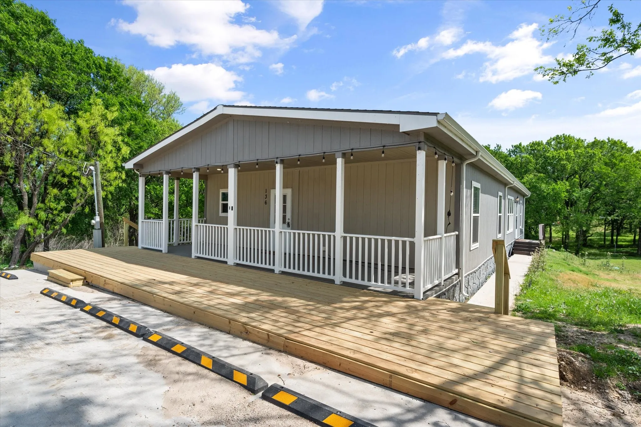Inviting covered front porch and oversized deck create the perfect space for relaxing near Richland Chambers Lake.