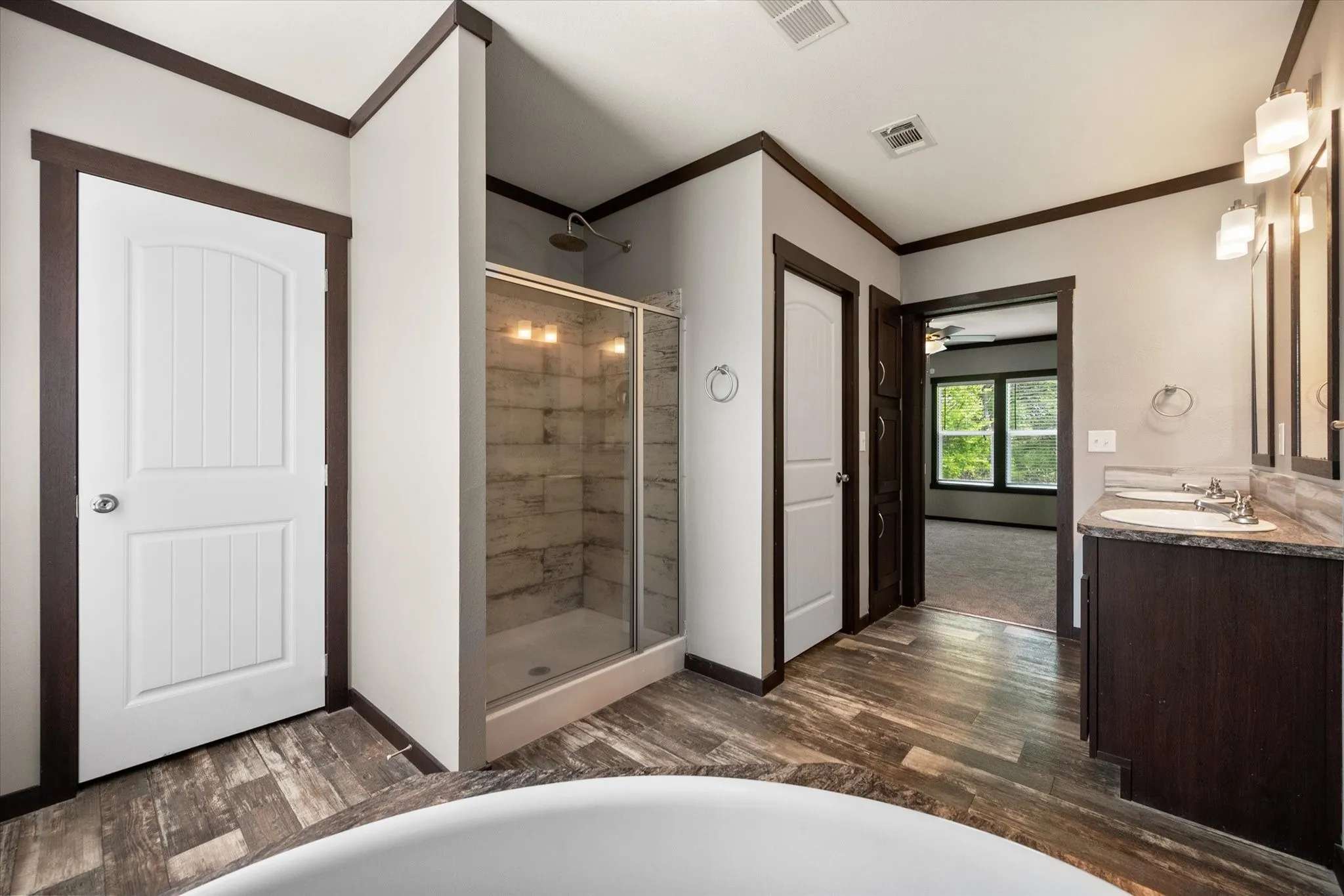 Spacious primary bath includes a separate walk-in shower and thoughtful split layout for added convenience.