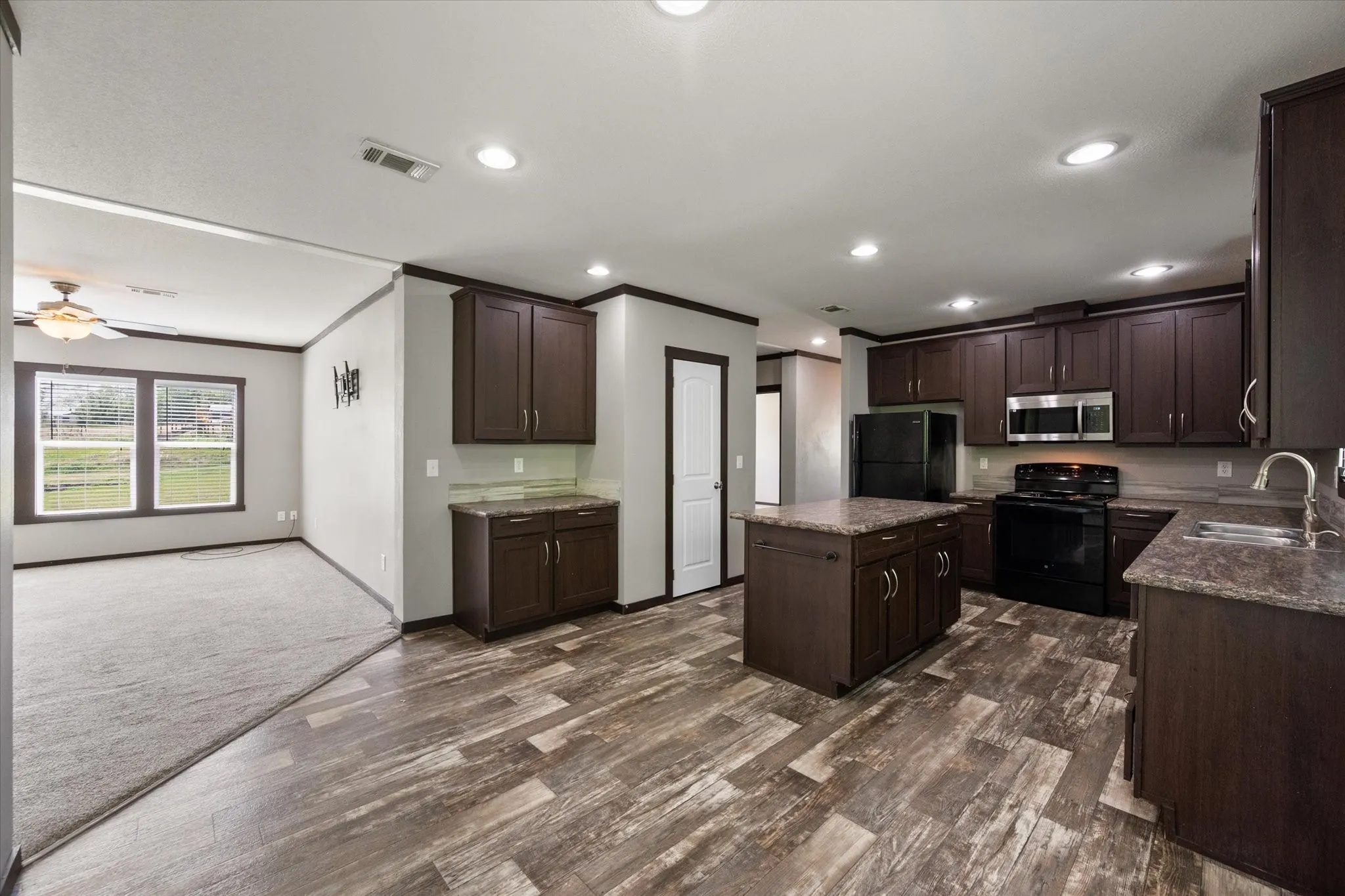 Spacious open-concept kitchen with oversized island and seamless flow into the living area—perfect for entertaining.