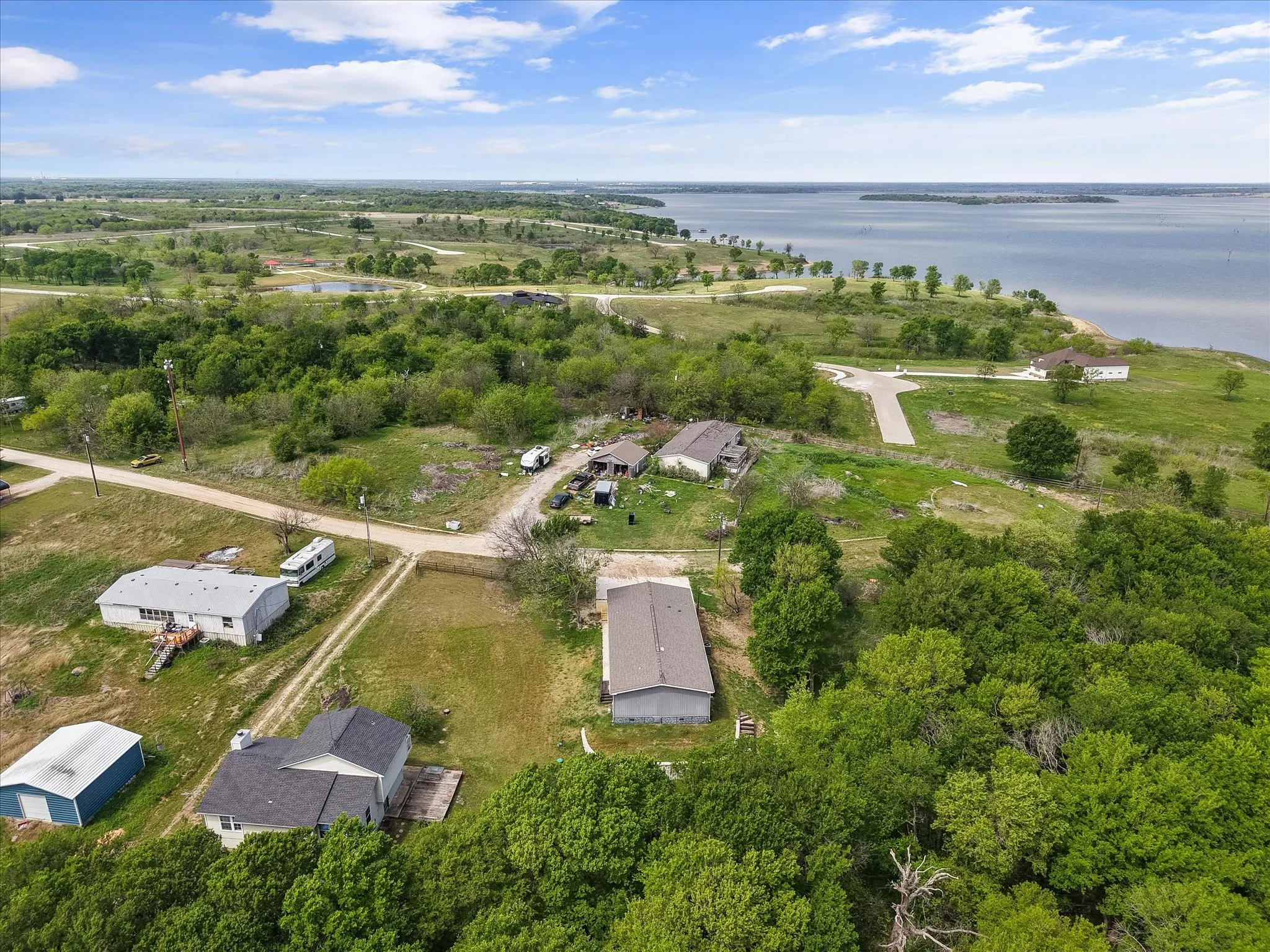 Overhead aerial highlights wooded privacy, spacious homesite, and the peaceful setting buyers love near Richland Chambers Lake.