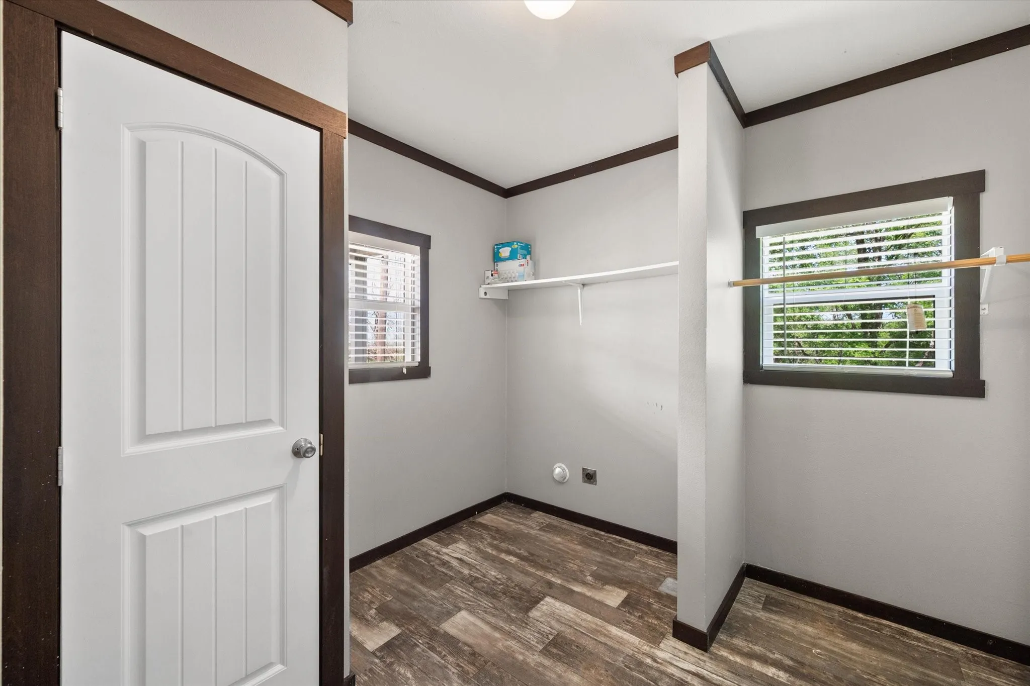 Functional laundry room with extra storage space and natural light designed for convenient everyday living.