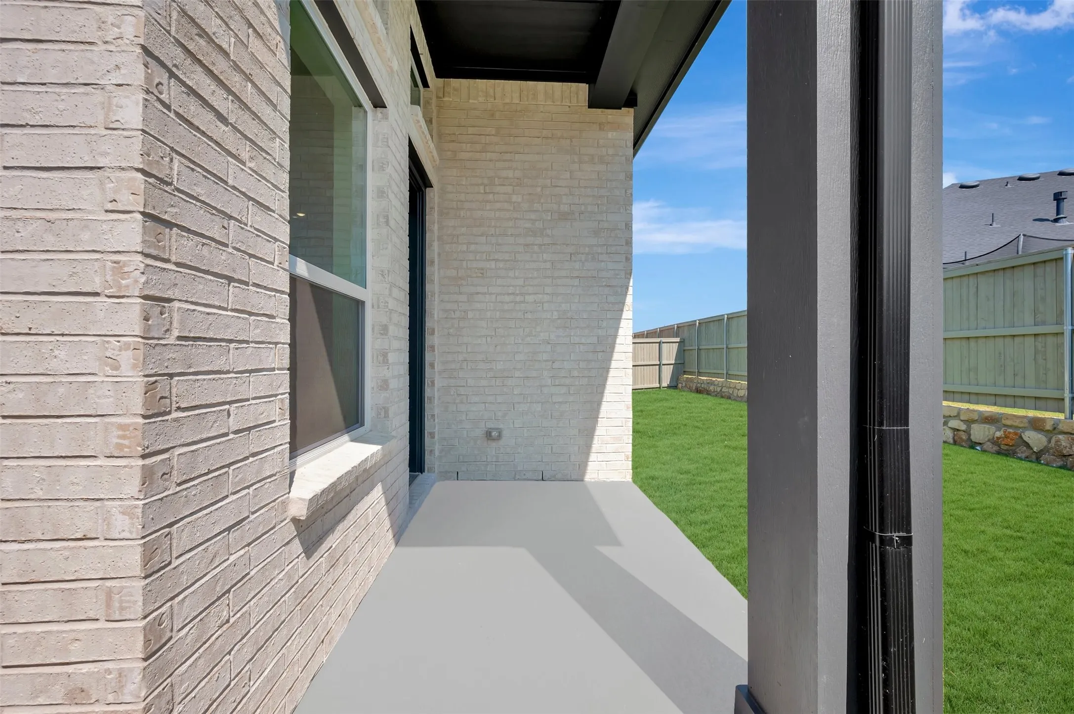 Covered patio featuring a concrete slab and a painted support column