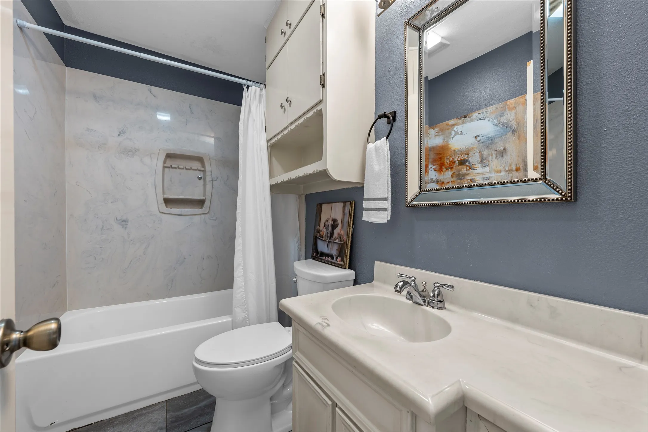 Bathroom with vanity and shower / tub combo