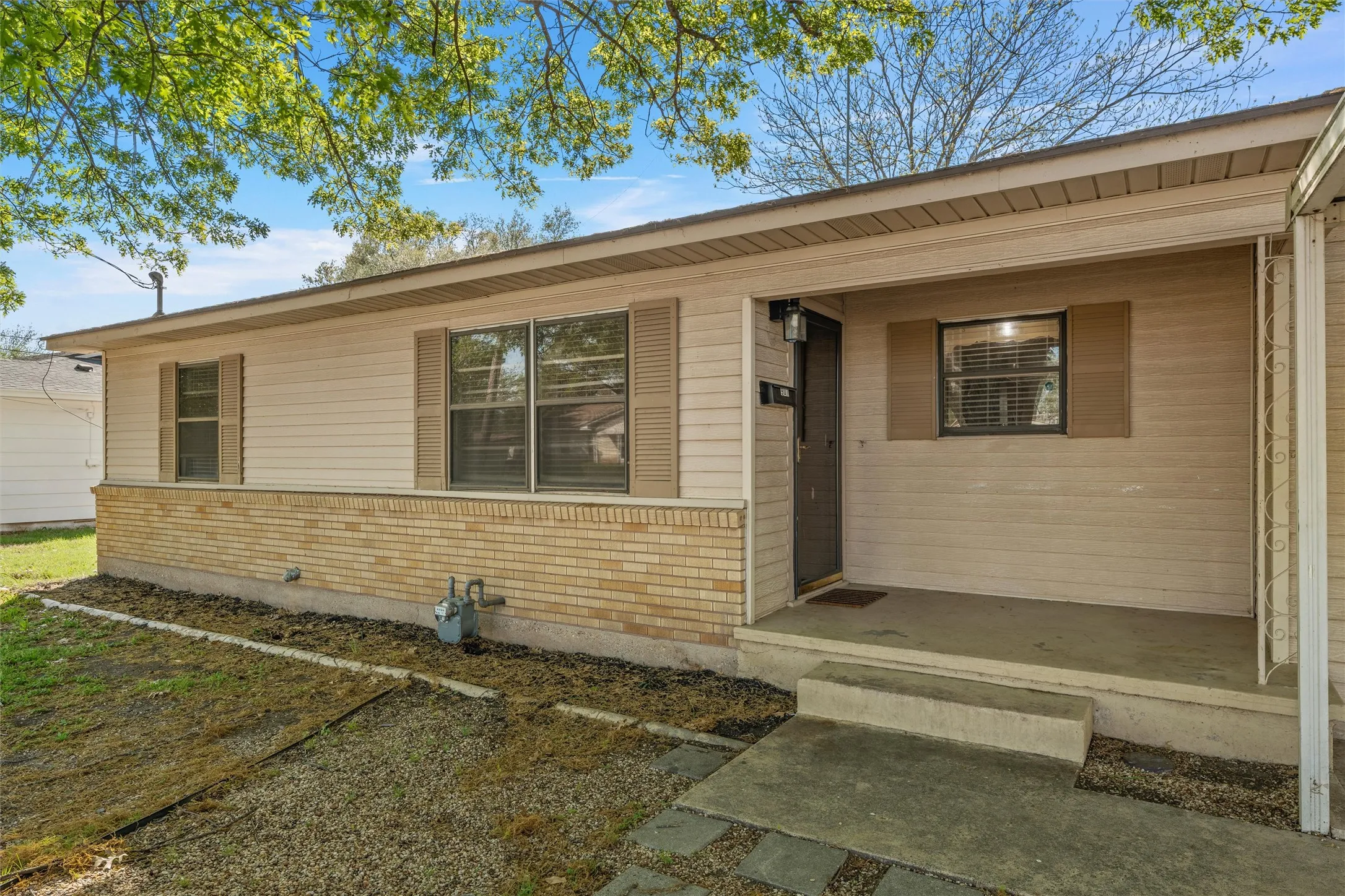 Entrance to property featuring brick siding
