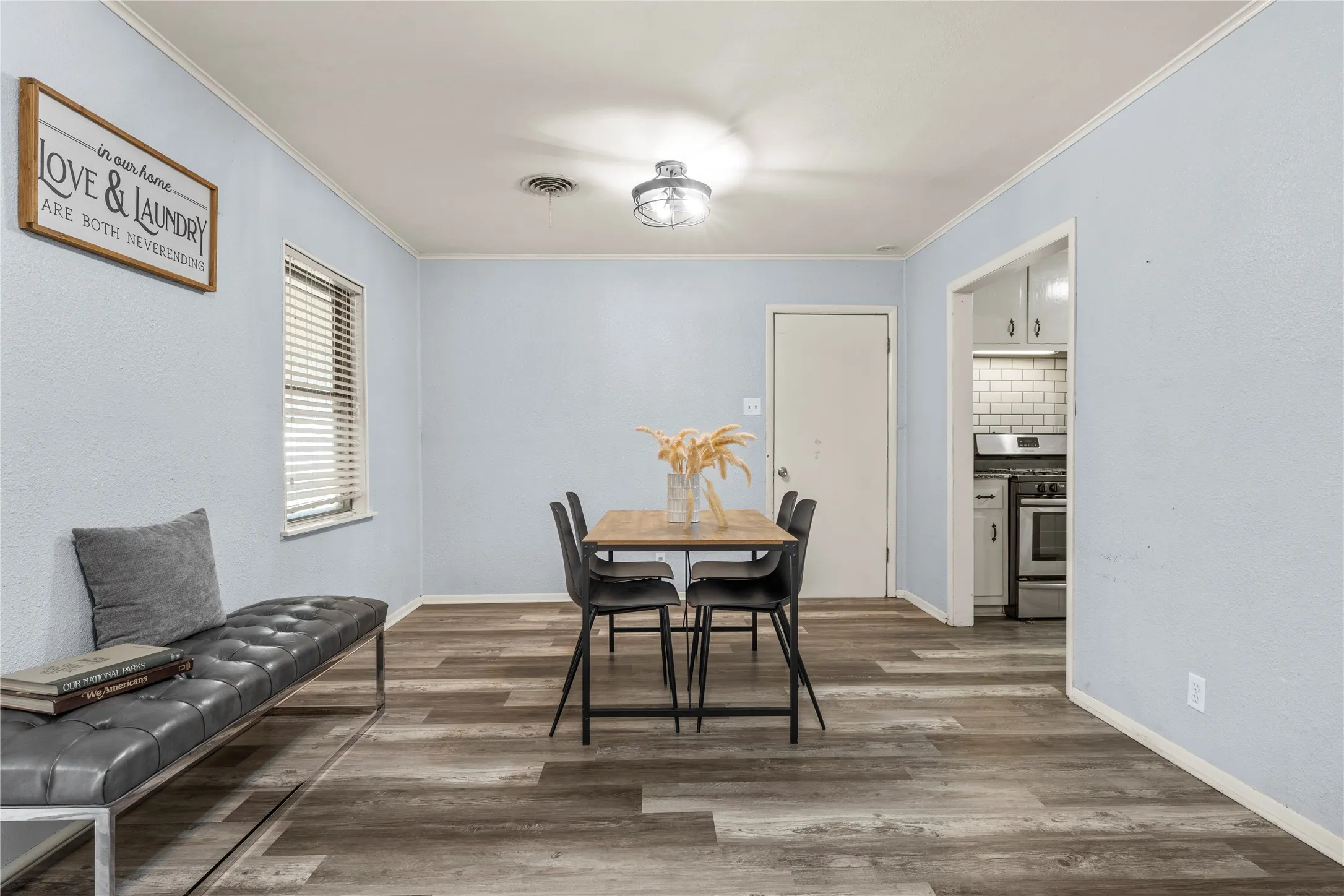 Dining area with crown molding and wood finished floors