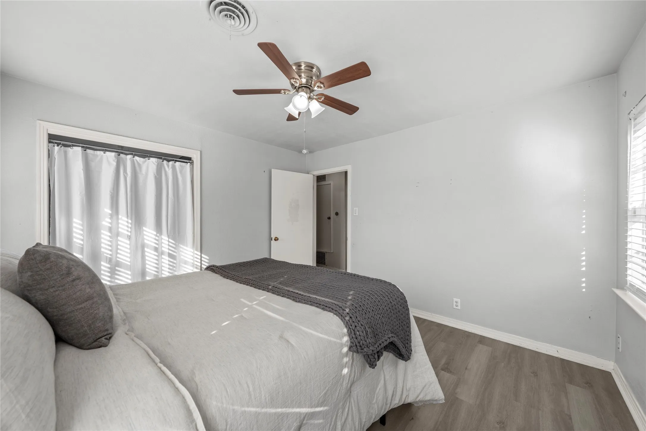 Bedroom with wood finished floors and ceiling fan