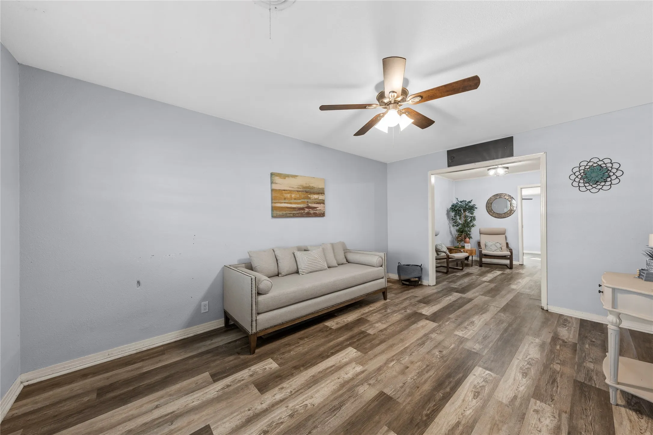Living area featuring wood finished floors and ceiling fan