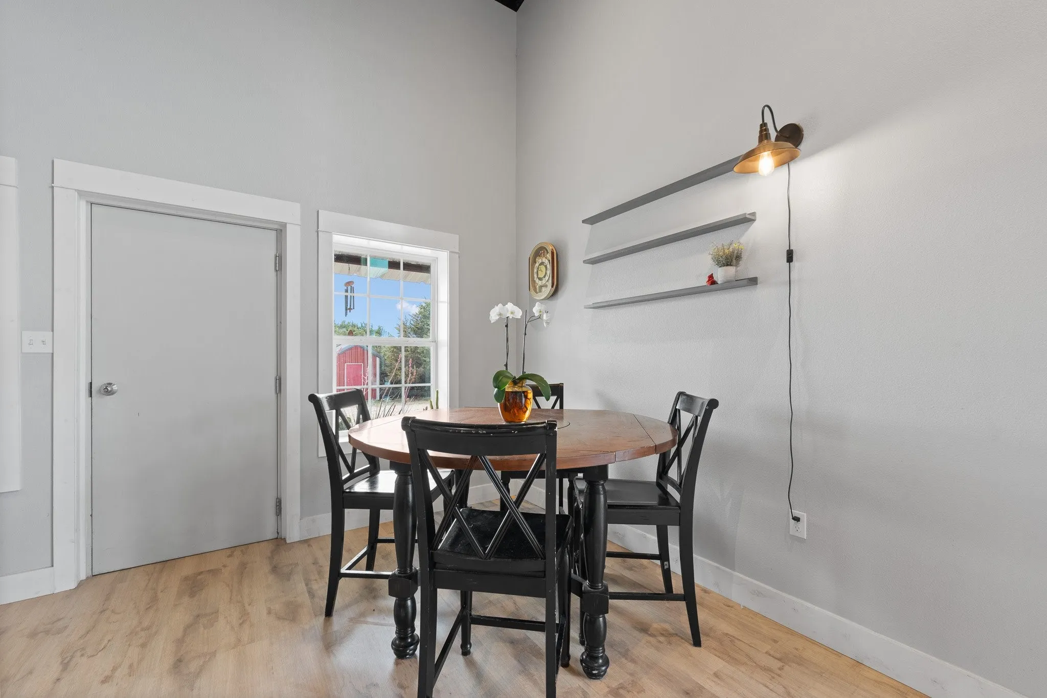 Dining space featuring light wood-type flooring and a high ceiling