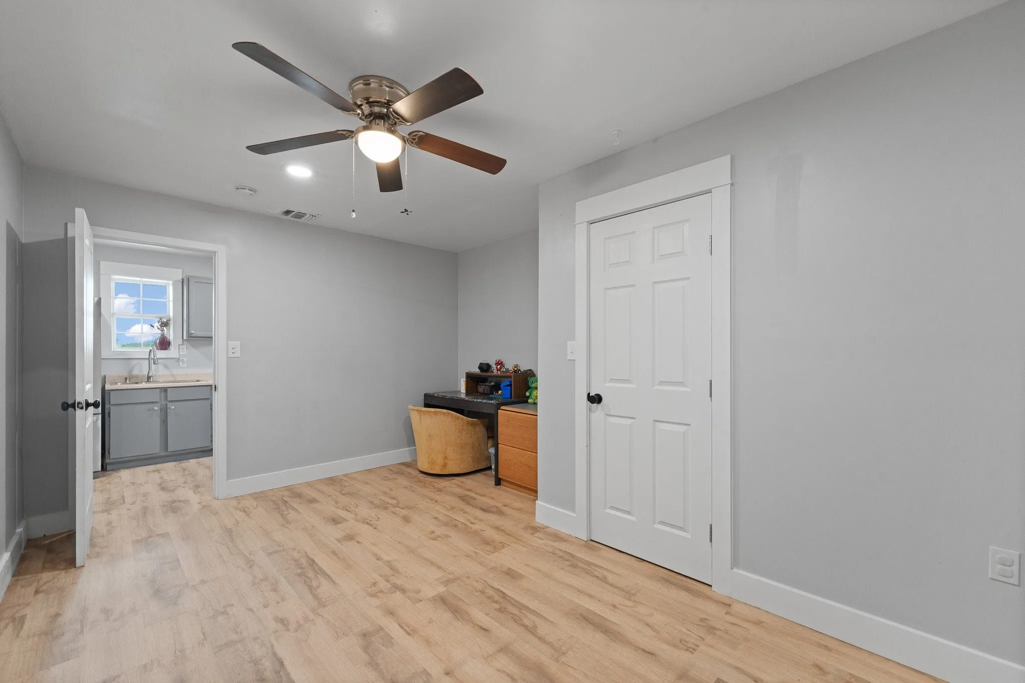Bedroom 2 featuring light wood-type flooring and ceiling fan