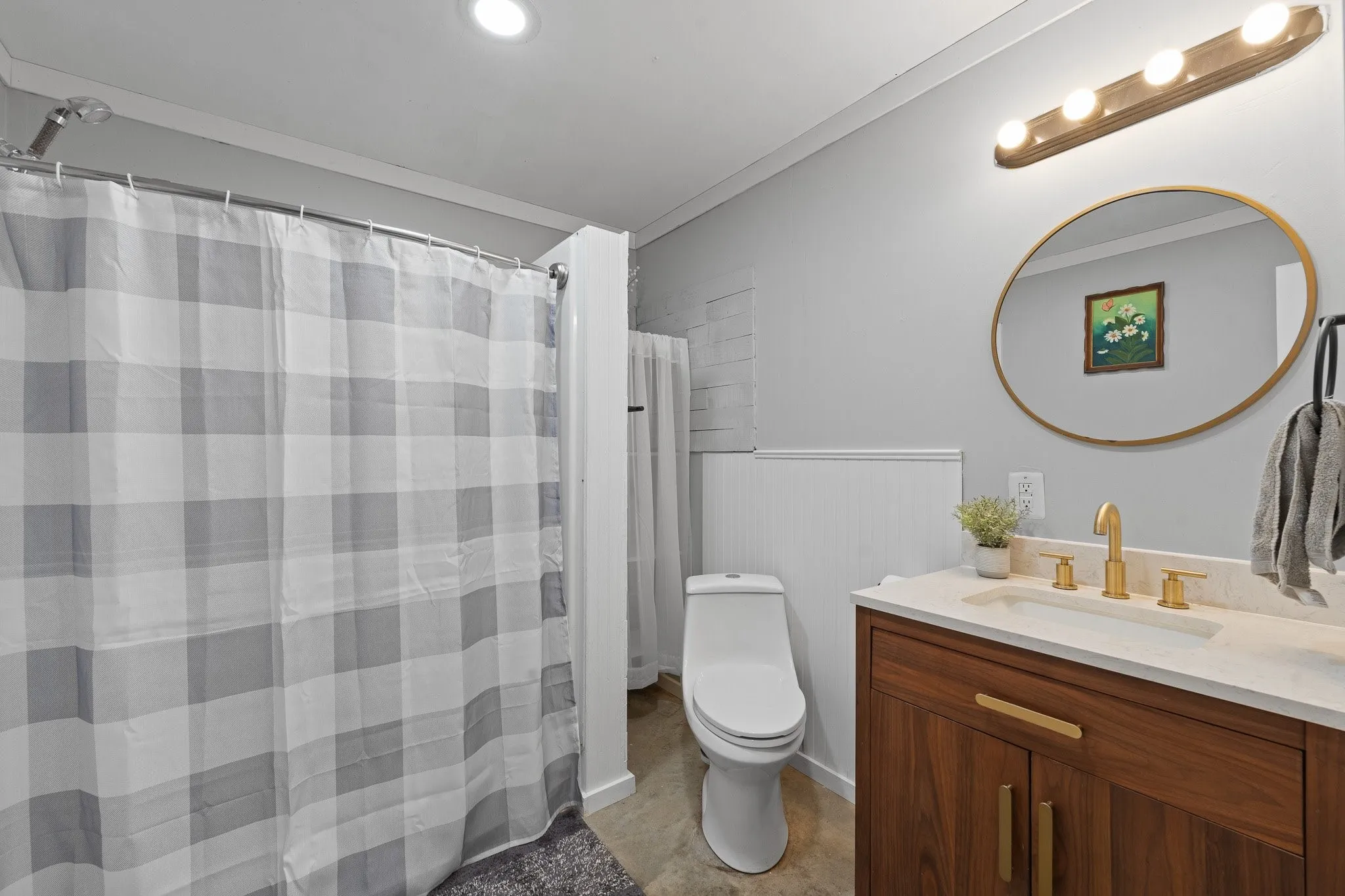 Bathroom with light wood finished floors and ceiling fan (Bed is Staged for visual purposes