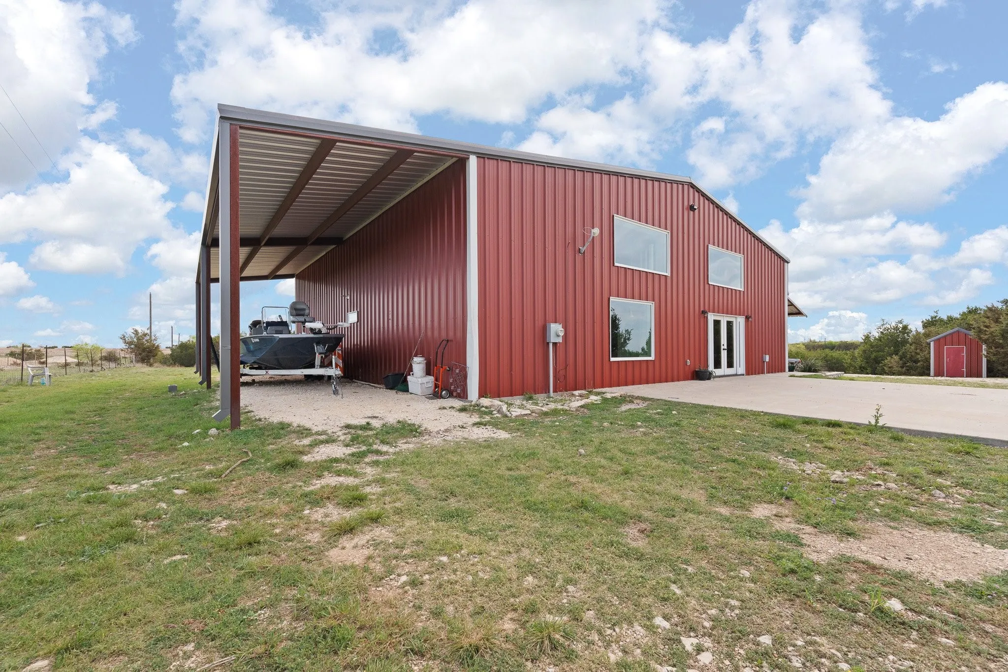View of pole building featuring a yard