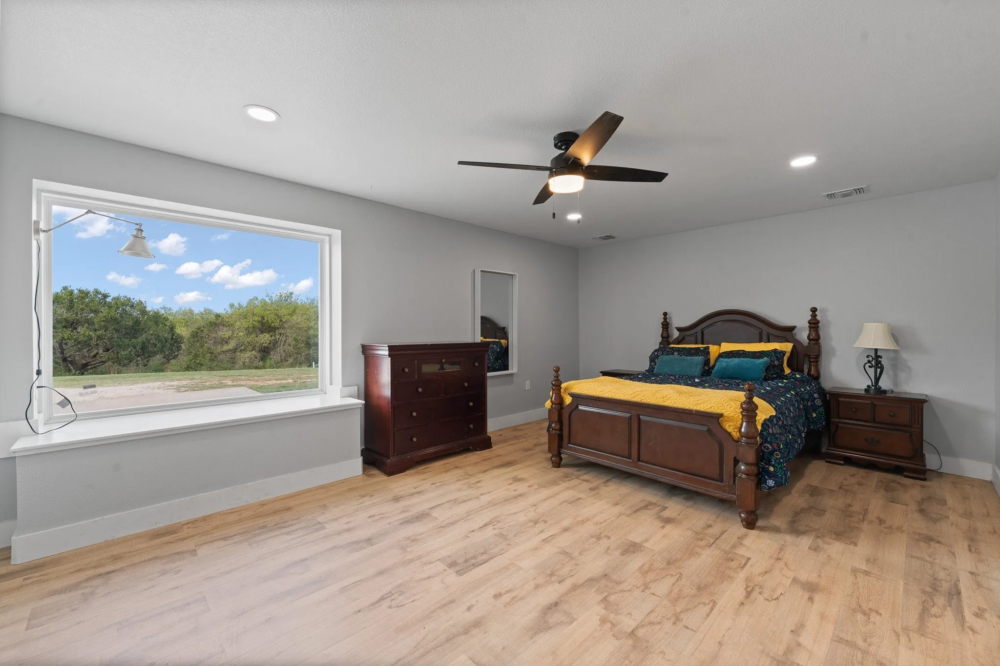 Primary Bedroom with light wood-style floors, a ceiling fan, and recessed lighting